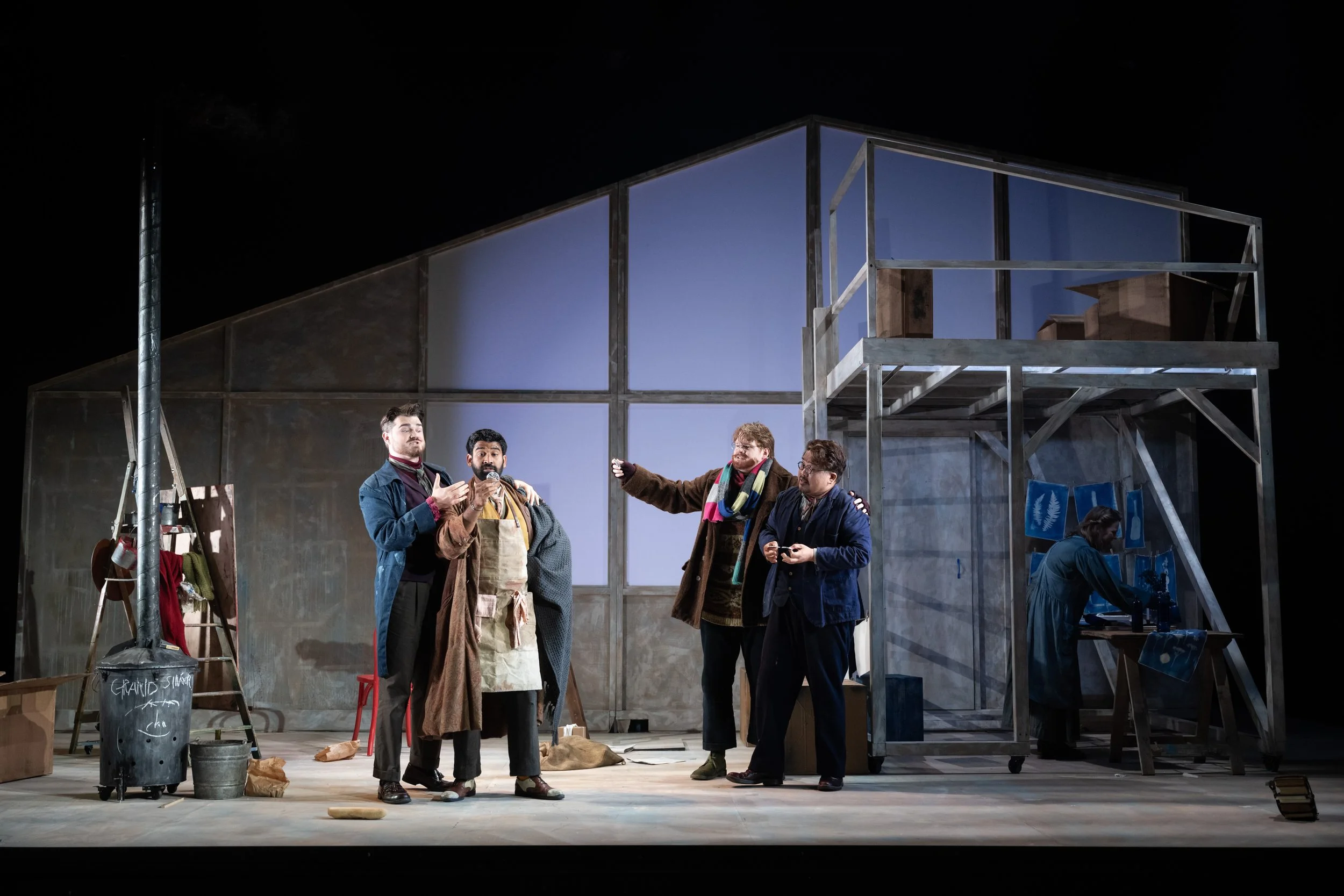 Actors on stage for Puccini's opera La Boheme.  Tenor Jung Soo Yun plays Rodolfo. Working with set designer Sarah Beaton. a wooden structure and moving platforms