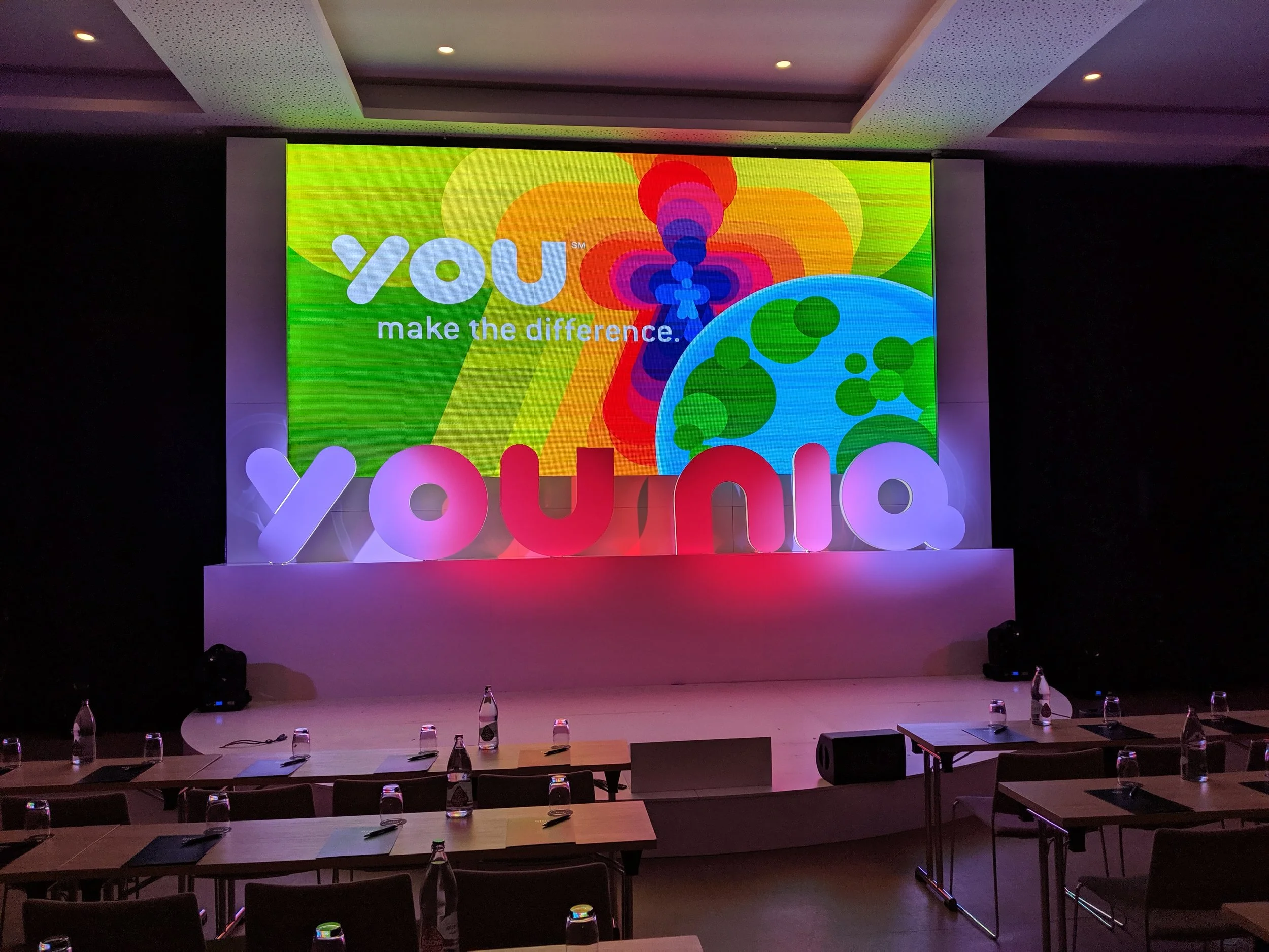 A stage at a conference for a global product launch in Madrid, scenery construction and lighting all to the company brand.