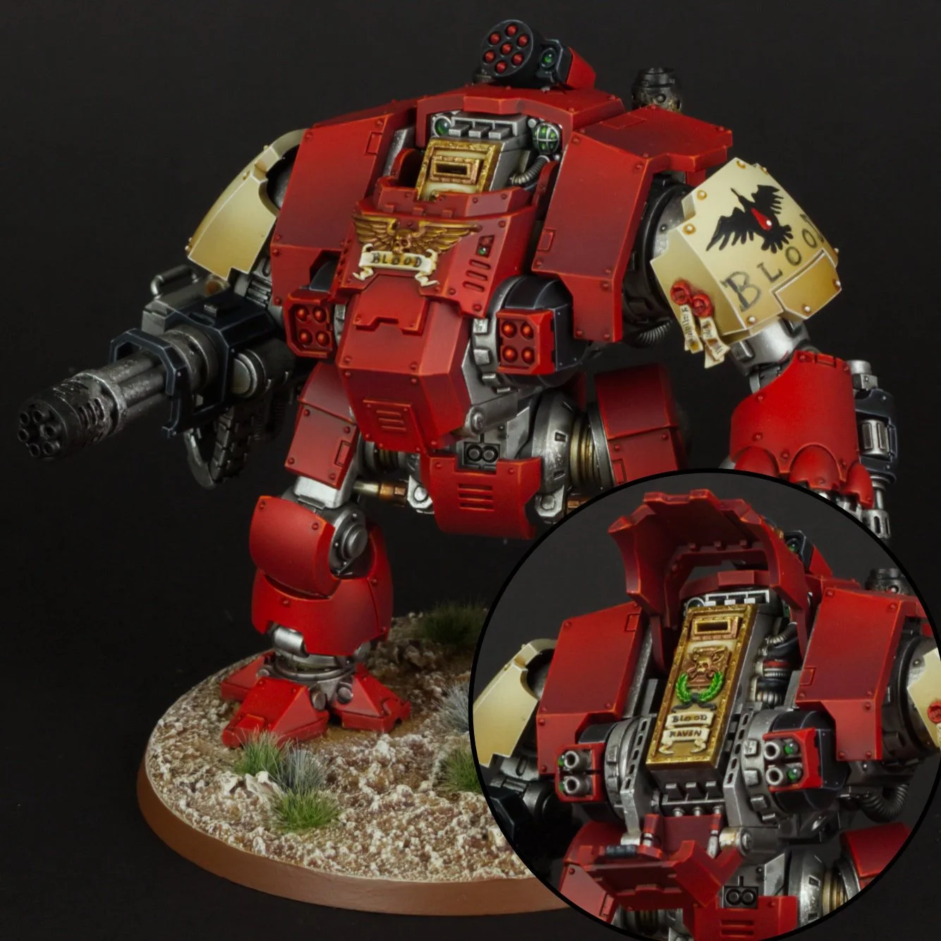 A detailed model of a warhammer 40k red power armor with a black eagle emblem on shoulder and a Gauntlet with a golden emblem. The model is on a textured base with grass and dirt, with a close-up inset showing the chest compartment with a sticker rea