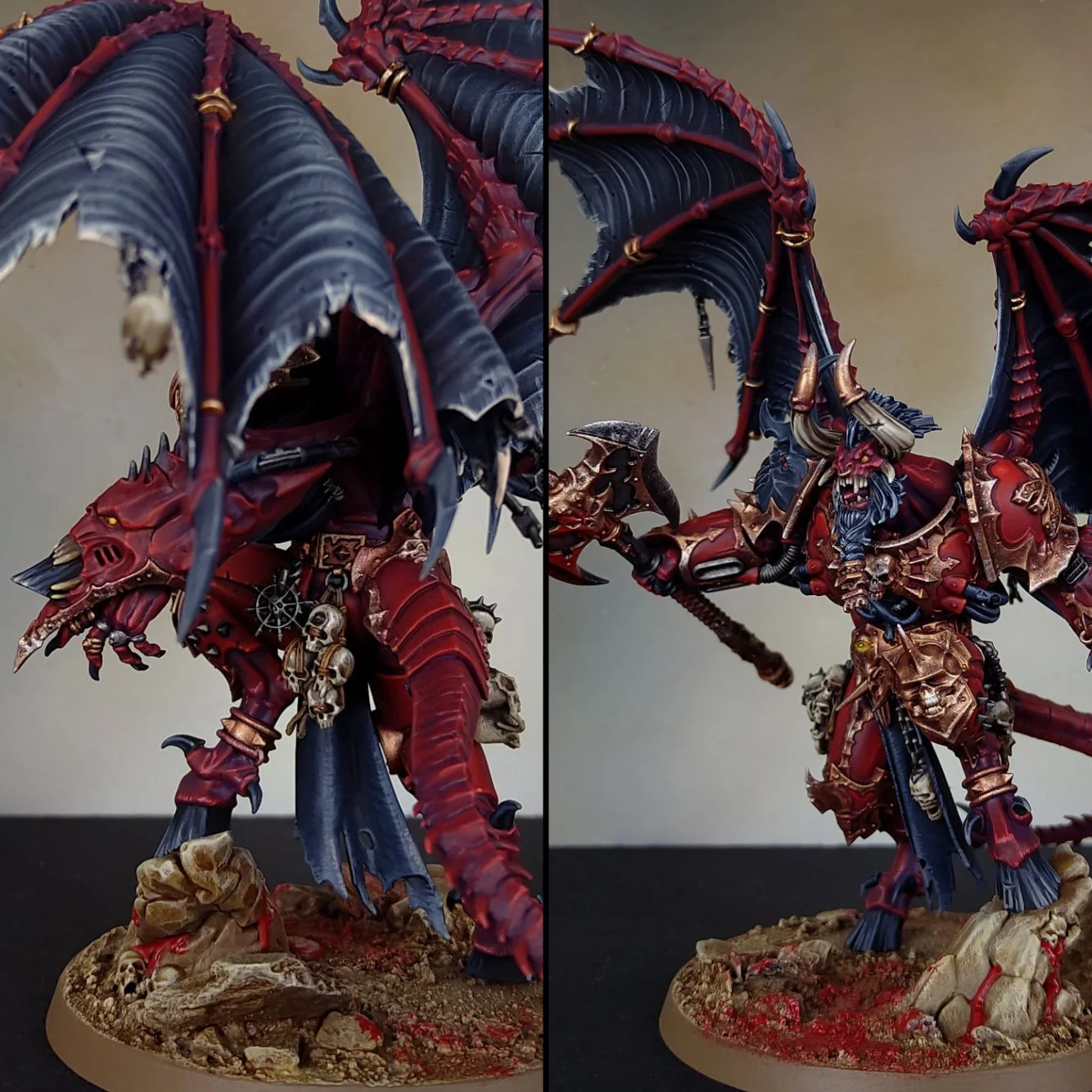 A detailed fantasy miniature figurine of a demon or chaos warrior, painted in red, black, and gold, with large bat-like wings, skull embellishments, and armor. The figure wields a weapon and stands on a textured base with skulls and rocks.