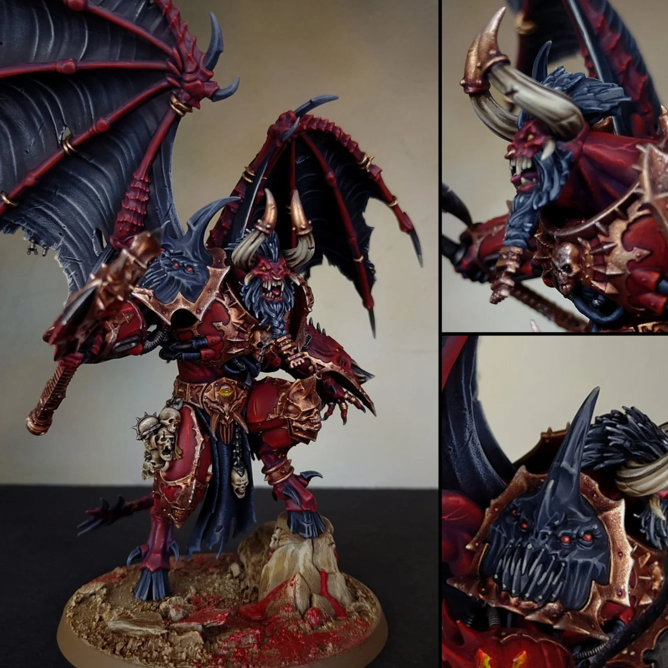 A detailed fantasy miniature figure of a demonic warrior with red and black armor, large horns, and dark wings, standing on a textured base with blood splatters.