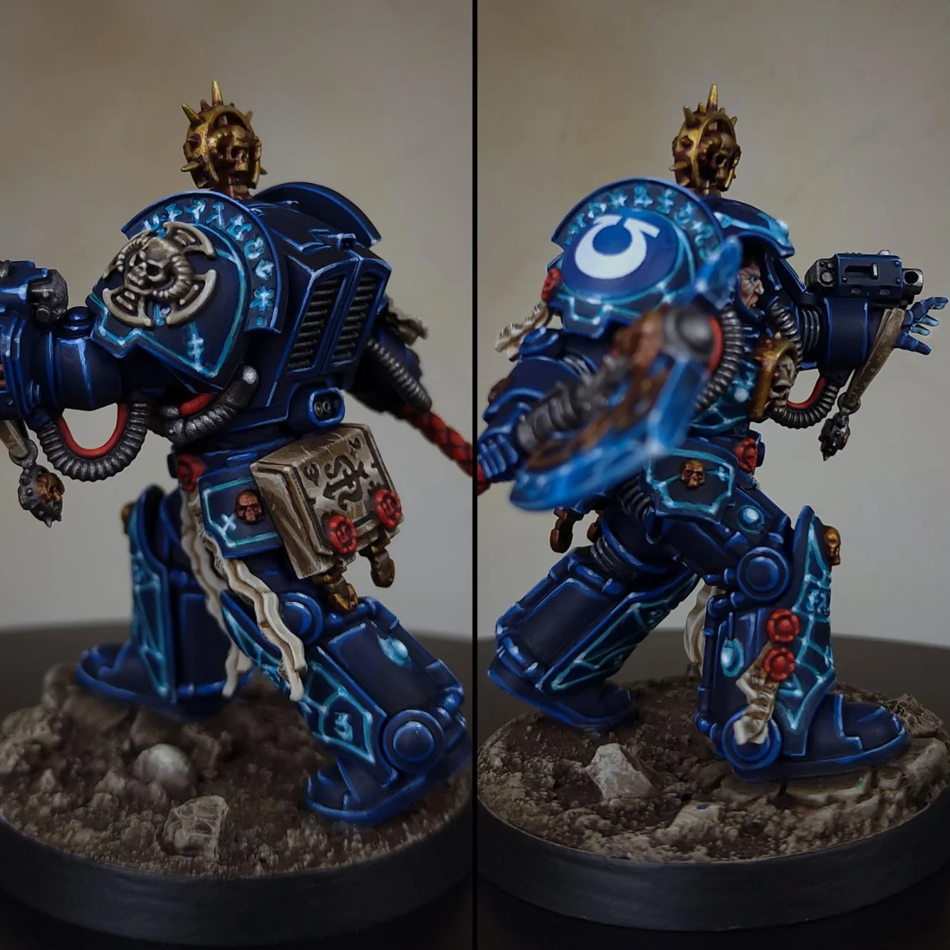 Two painted miniature figurines of heavily armored soldiers with blue armor and skull motifs, standing on rocky bases.