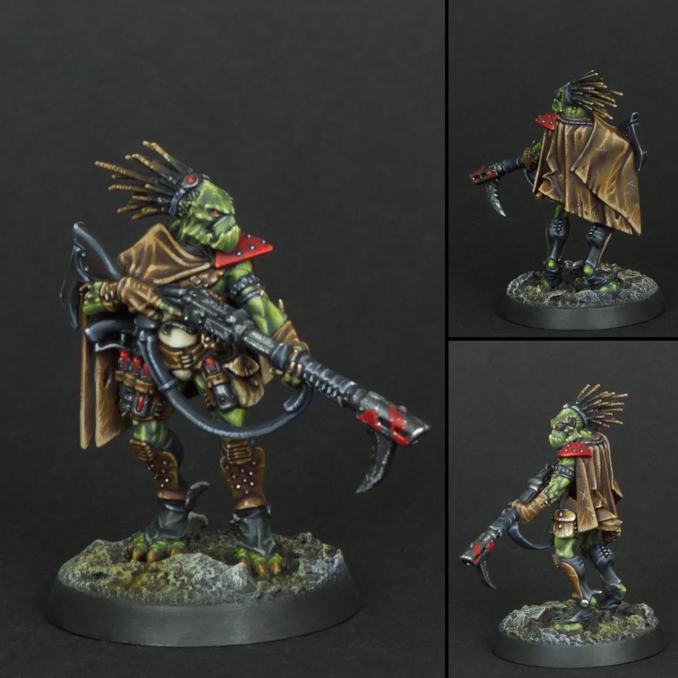 A detailed miniature figure of a sci-fi or fantasy alien warrior with green skin, dreadlock-like hair, and a tribal aesthetic, holding a large weapon, with a cape and armor, standing on a textured rocky base.