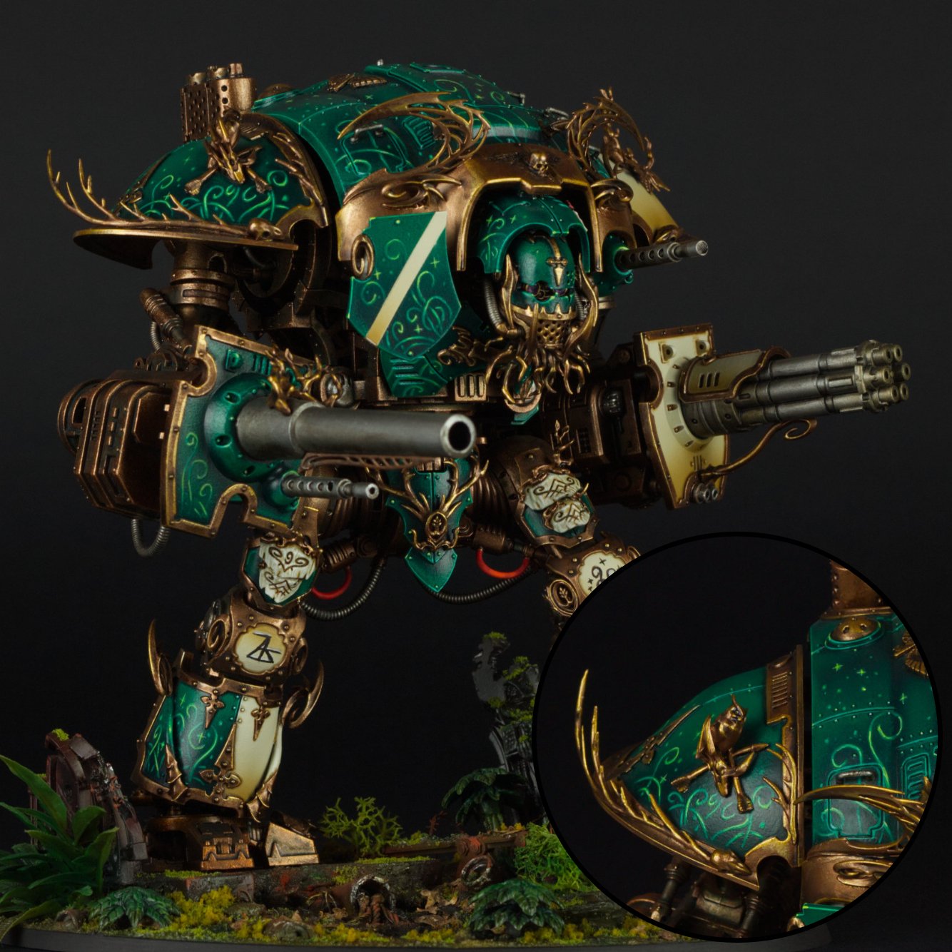A detailed model of a war mech decorated in green and gold with intricate designs, featuring large guns and armor, set on a diorama with plants and rocks.