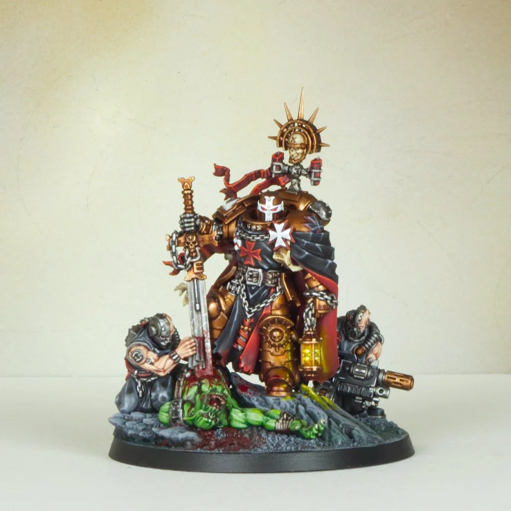 A detailed miniature or model of a warrior in black and gold armor, holding a sword and a gun, with a skull and halo on his back, surrounded by two kneeling soldiers and a green zombie on a textured base.