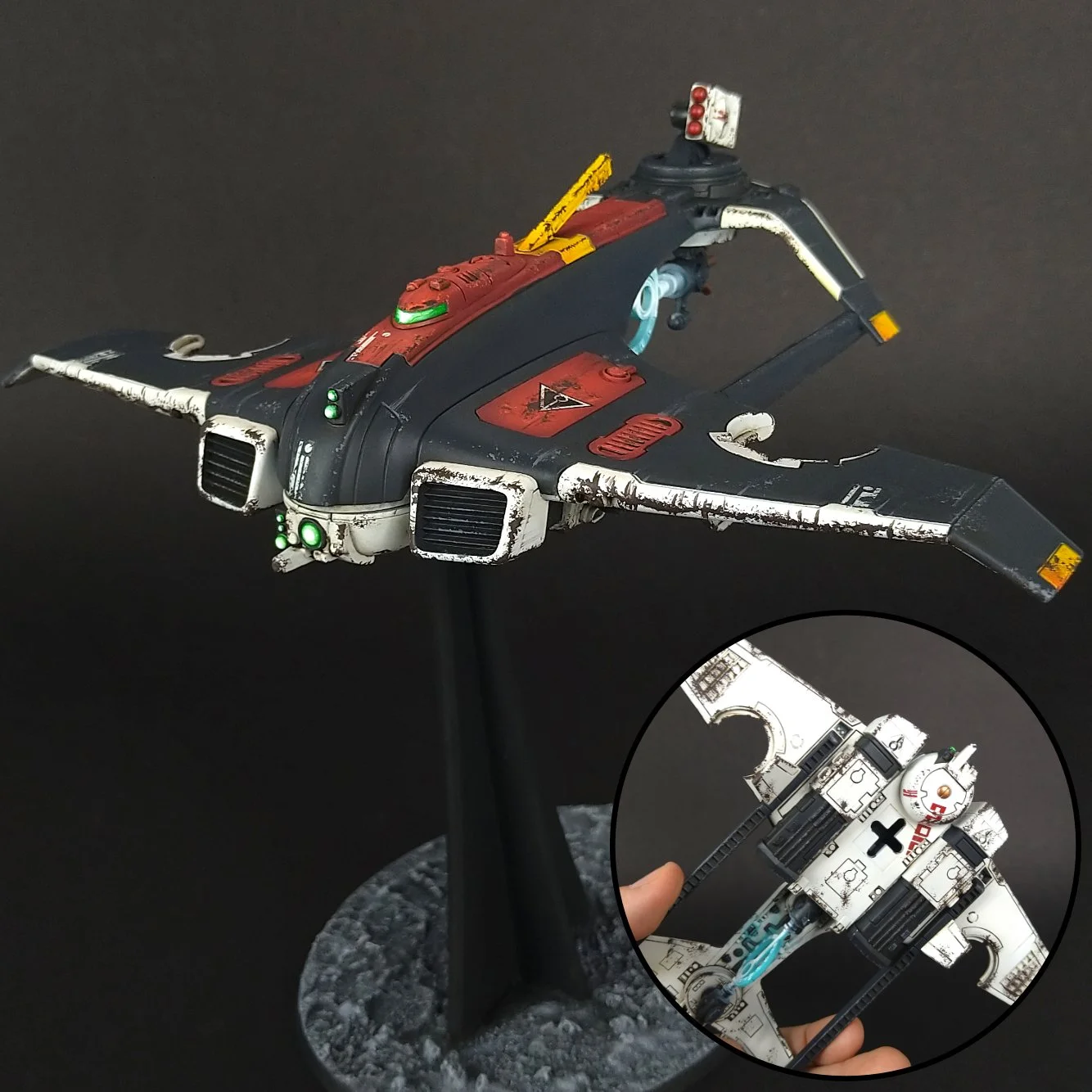 Model spaceship with worn paint and glowing lights on display, with insets showing detailed close-ups of its electronic components and circuitry.