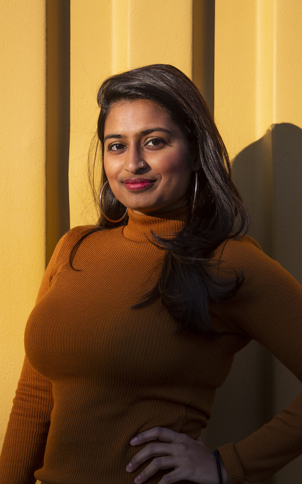 Portrait of a woman with a yellow backdrop. Upstate New York Photographer.
