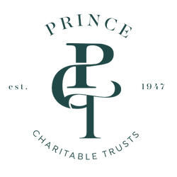 Logo with the word 'PRINCE' above a geometric symbol combining the letters P, R, I, N, C, and E, along with the words 'EST. 1979' and 'STRENGTH & DIGNITY'.