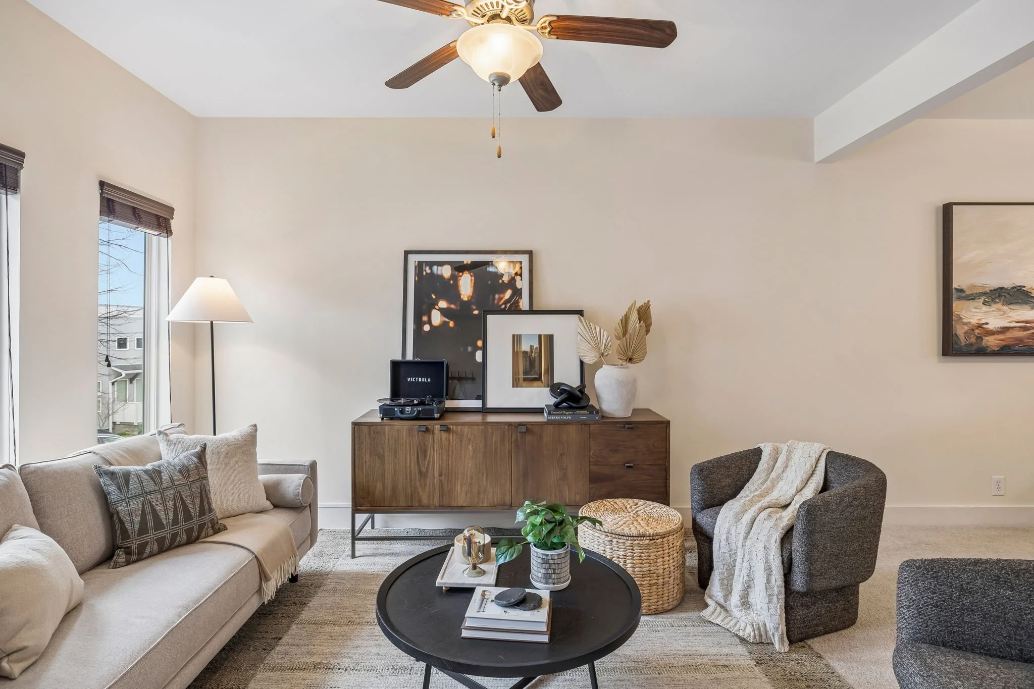 Living Room Image of Furnished Area with Rug, Sofa, Chairs, Sideboard and Art on Top with Record Player Books and Decor