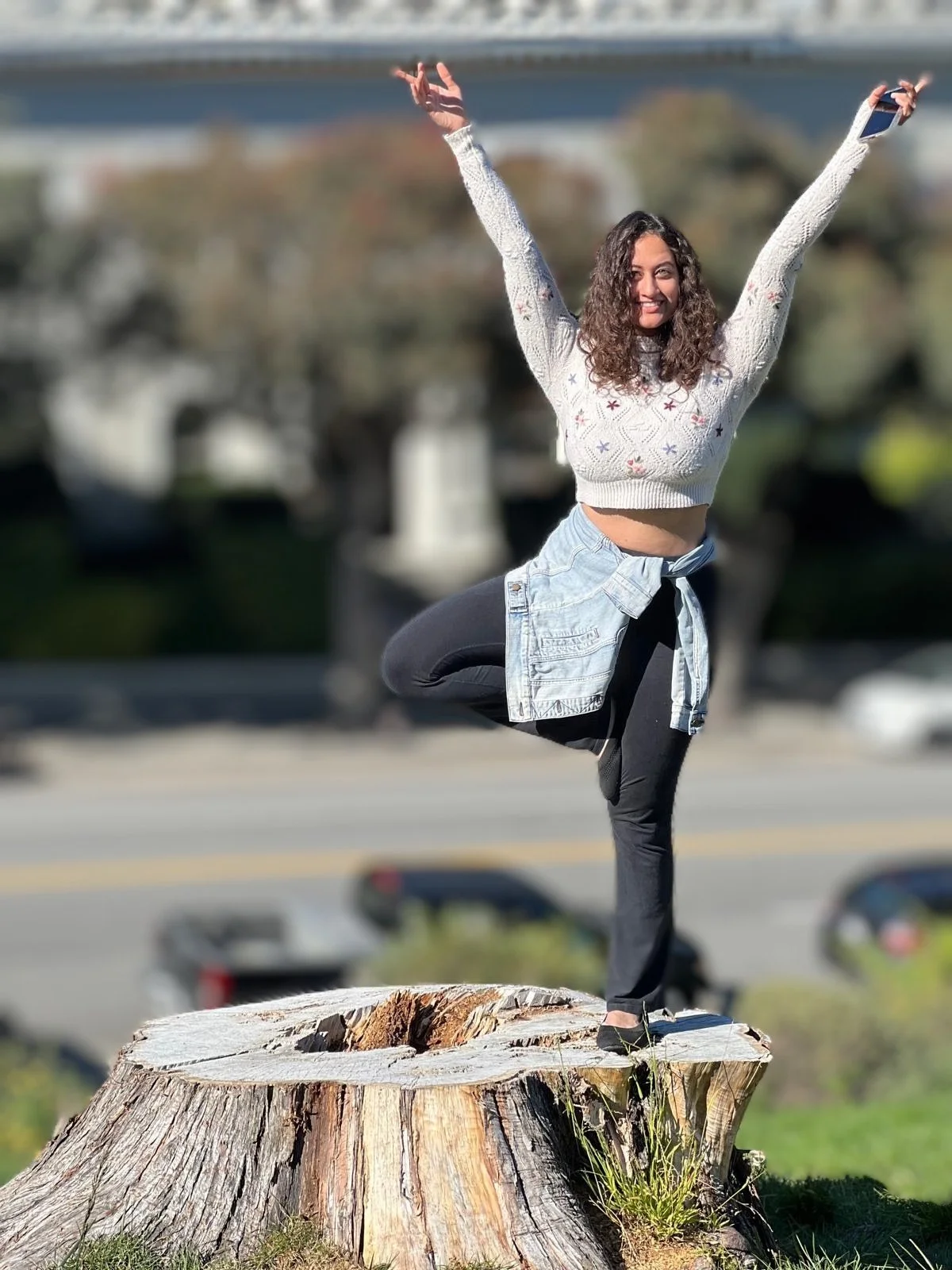 woman standing on one leg with arms extended