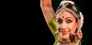 photo of woman in traditional Indian dress - close up photo - wearing head piece and hand is outstreched