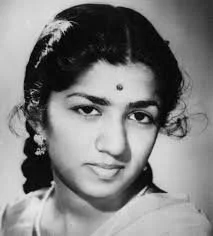 Black and white portrait of a young Asha Bhonsle with traditional Indian attire, earrings, and a bindi on her forehead.