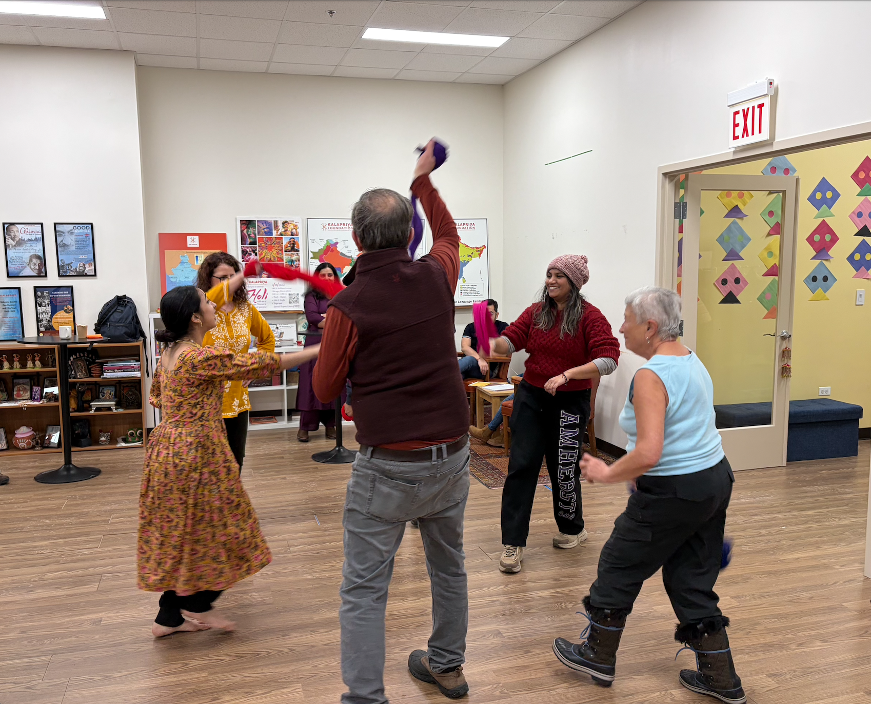 Harini facilitating a folk dance workshop with winter harvest fest attendees