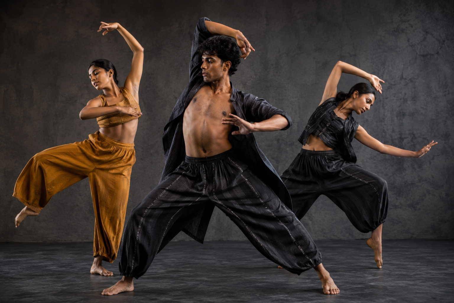 3 dancers wearing black and gold costumes