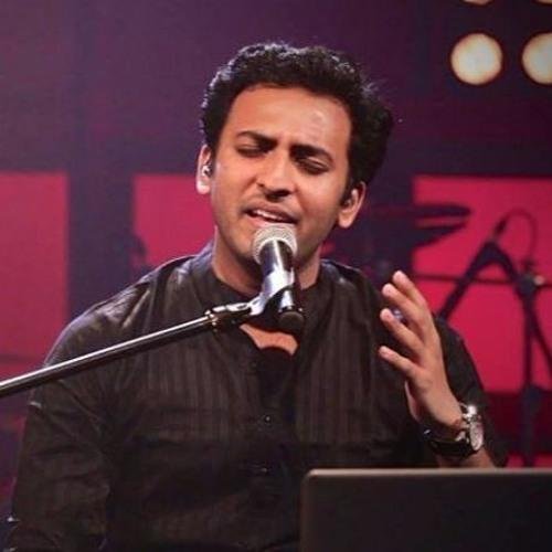 man singing into a microphone - artist is Shiv Subramaniam
