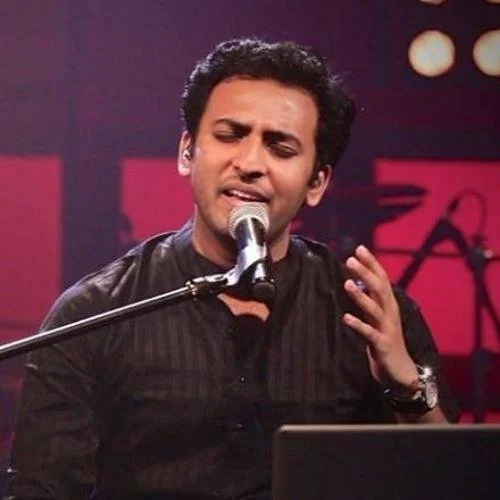 man singing into a microphone - artist is Shiv Subramaniam