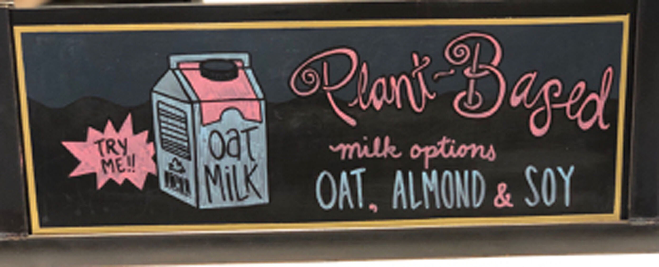 Dairy-free in your coffee shown on one or many hand-drawn signs