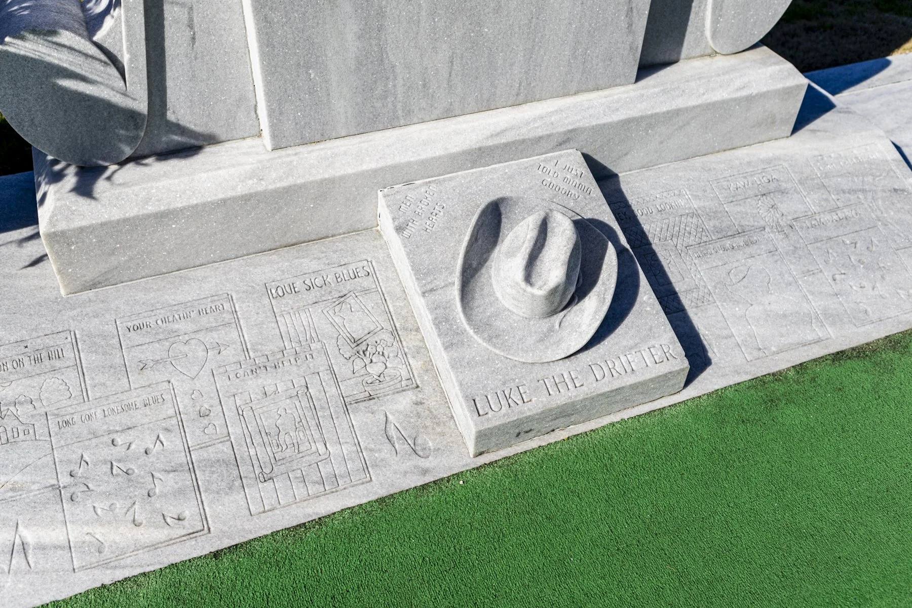 Some of Hank's most popular songs along with his hat were incorporated into his tombstone.