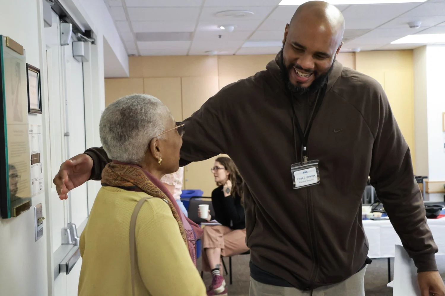 MIKE Board of Directors President Tyrell Comeaux greets retreat coach Deborah Wilds of the Murdock Trust