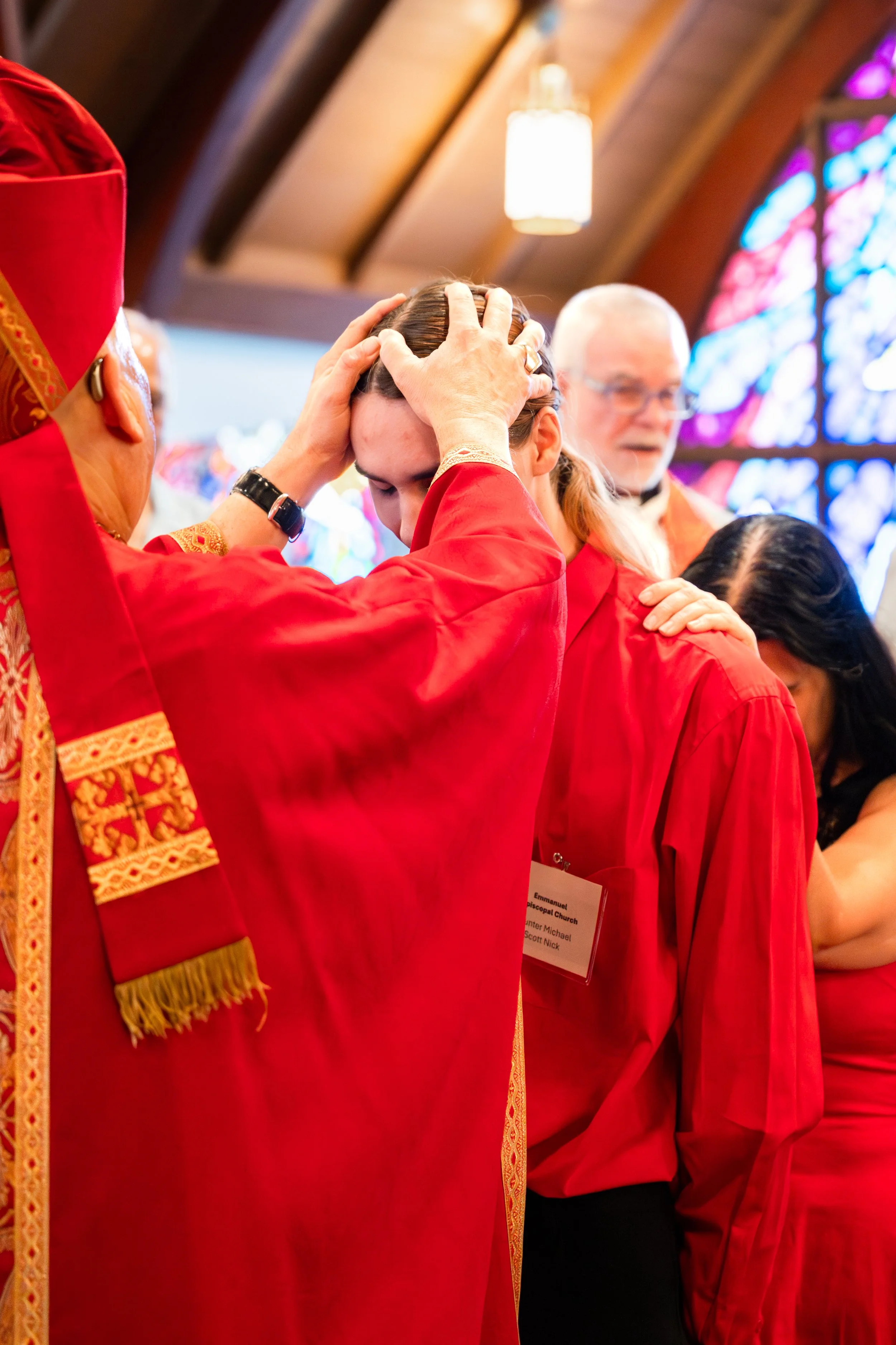 Bishop blessing man at his confirmation church event