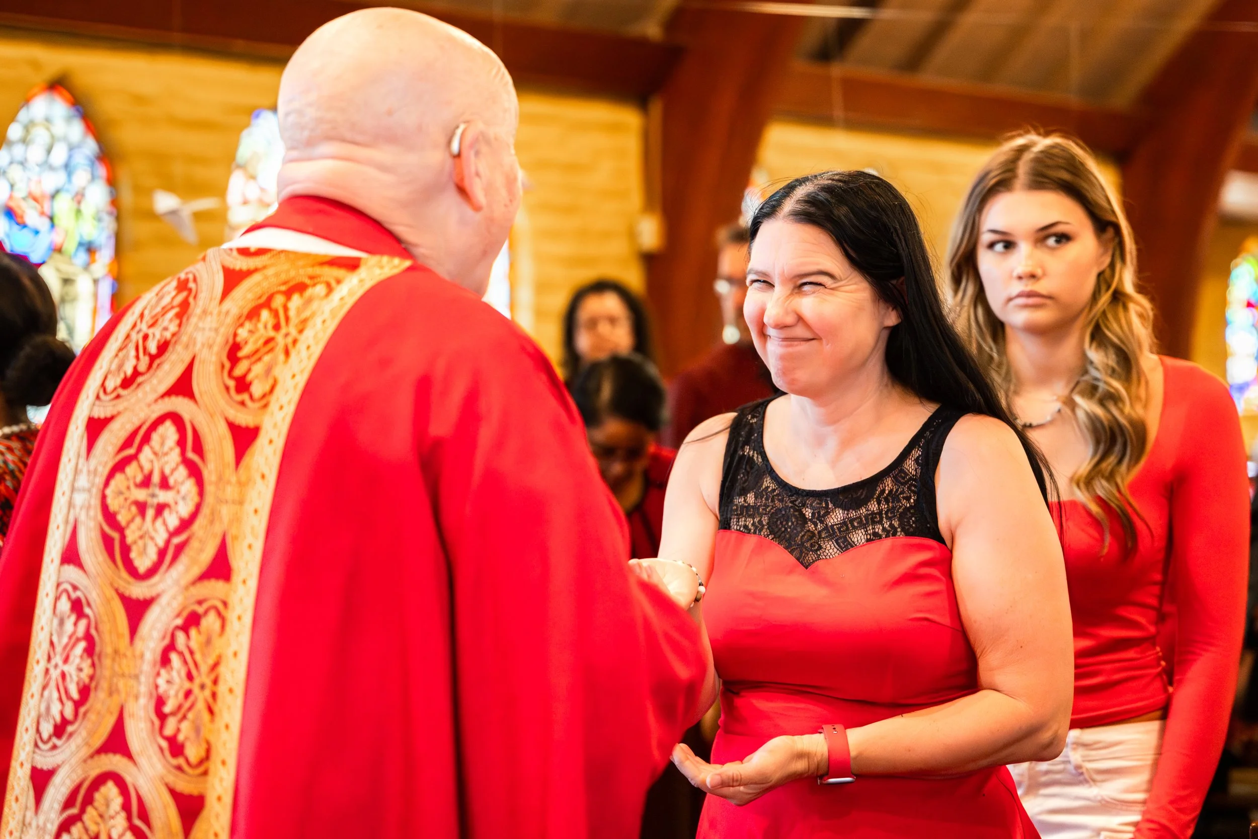 Woman smiling as she receives communion at church event