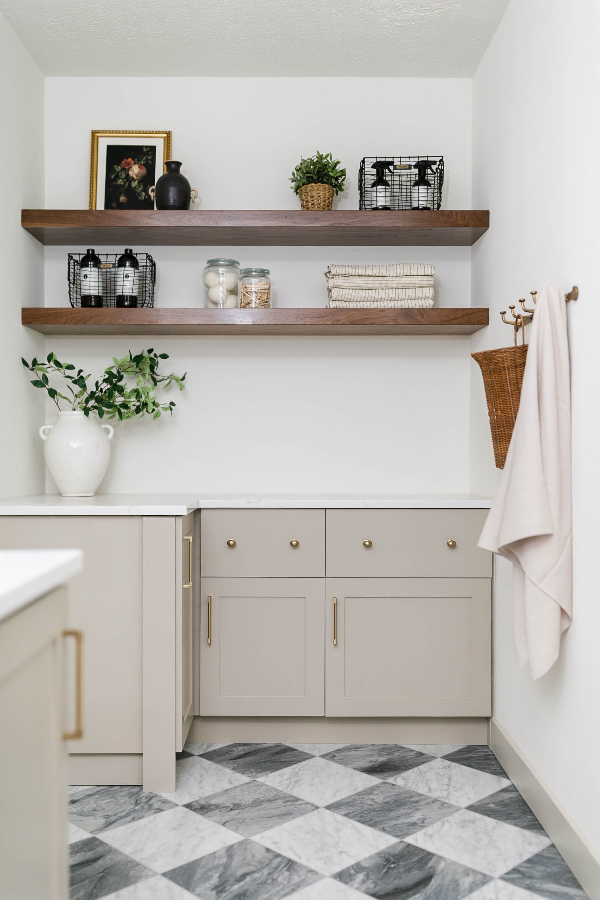 Custom utility and laundry room with built-in cabinetry, open shelving and patterned stone flooring designed by Ashley Kiely Living in Portland, Oregon.