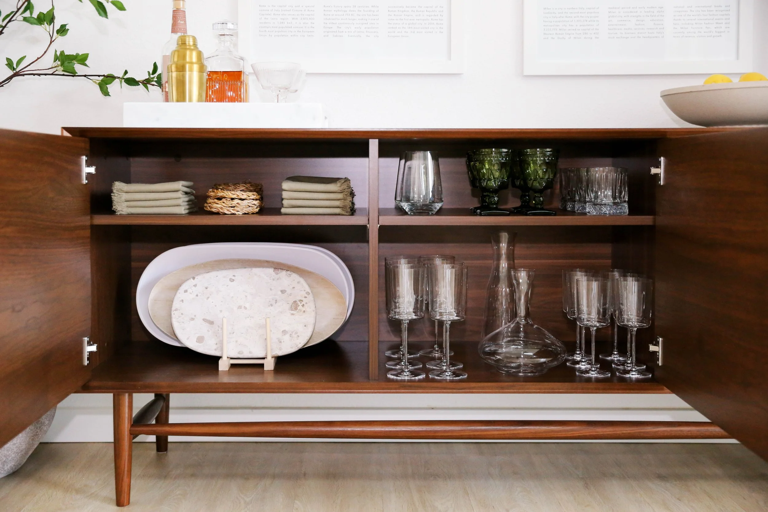 Professionally organized wood cabinet with glassware and serving pieces