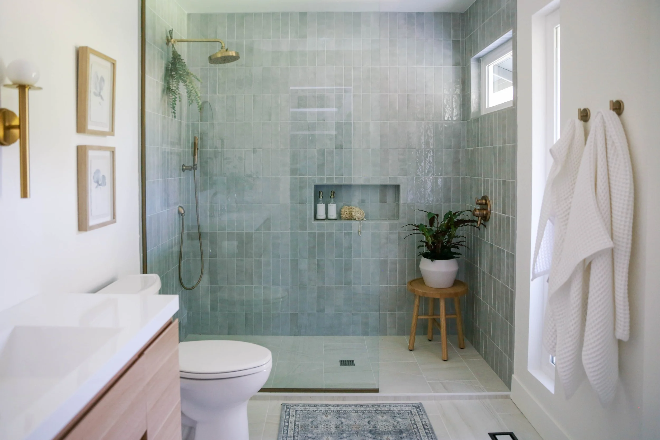 Portland bathroom remodel with grey tile walk-in shower, brass fixtures and custom vanity by Ashley Kiely Living.