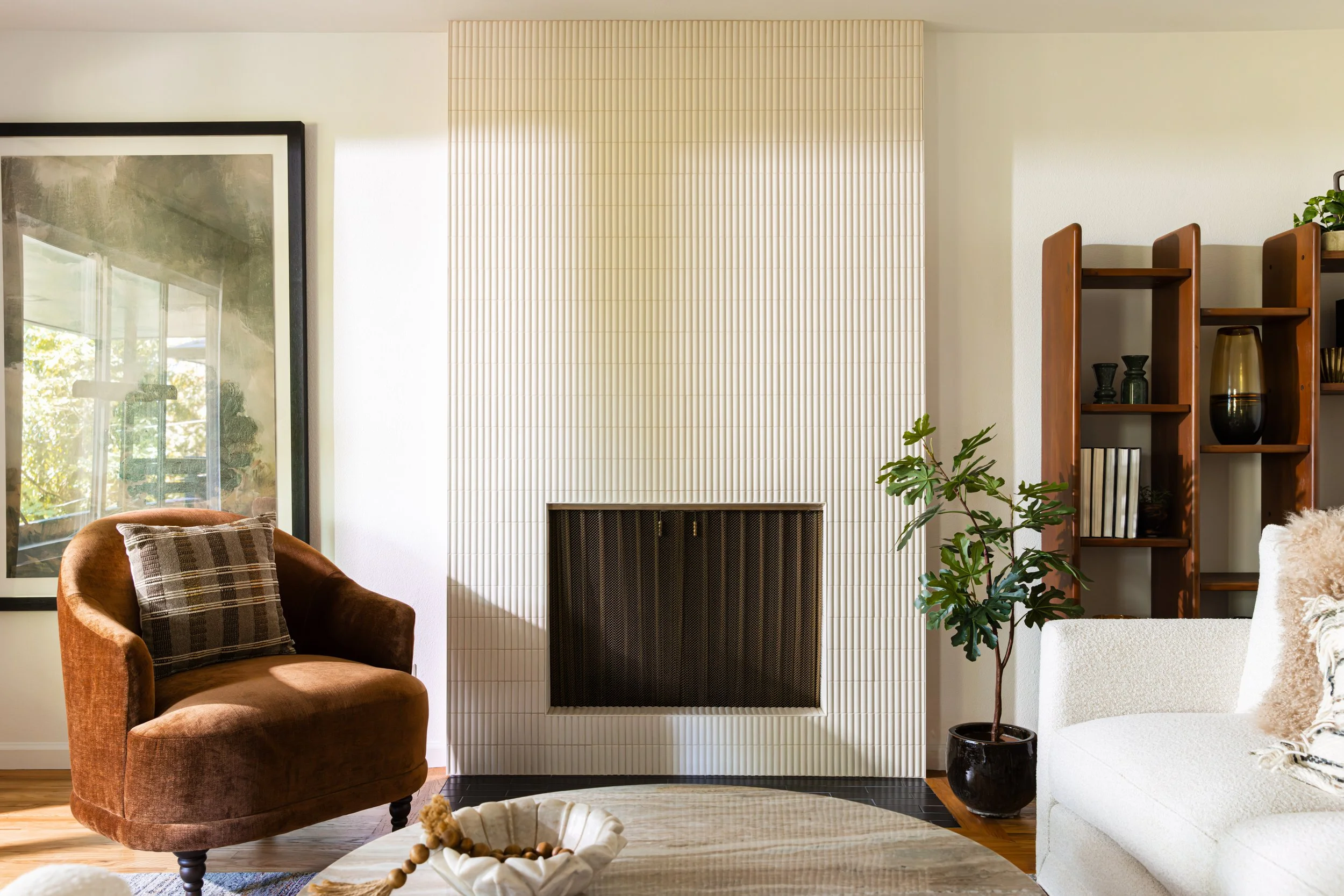 Living room fireplace with floor-to-ceiling fluted tile surround in a mid-century modern Portland home remodel by Ashley Kiely Living.
