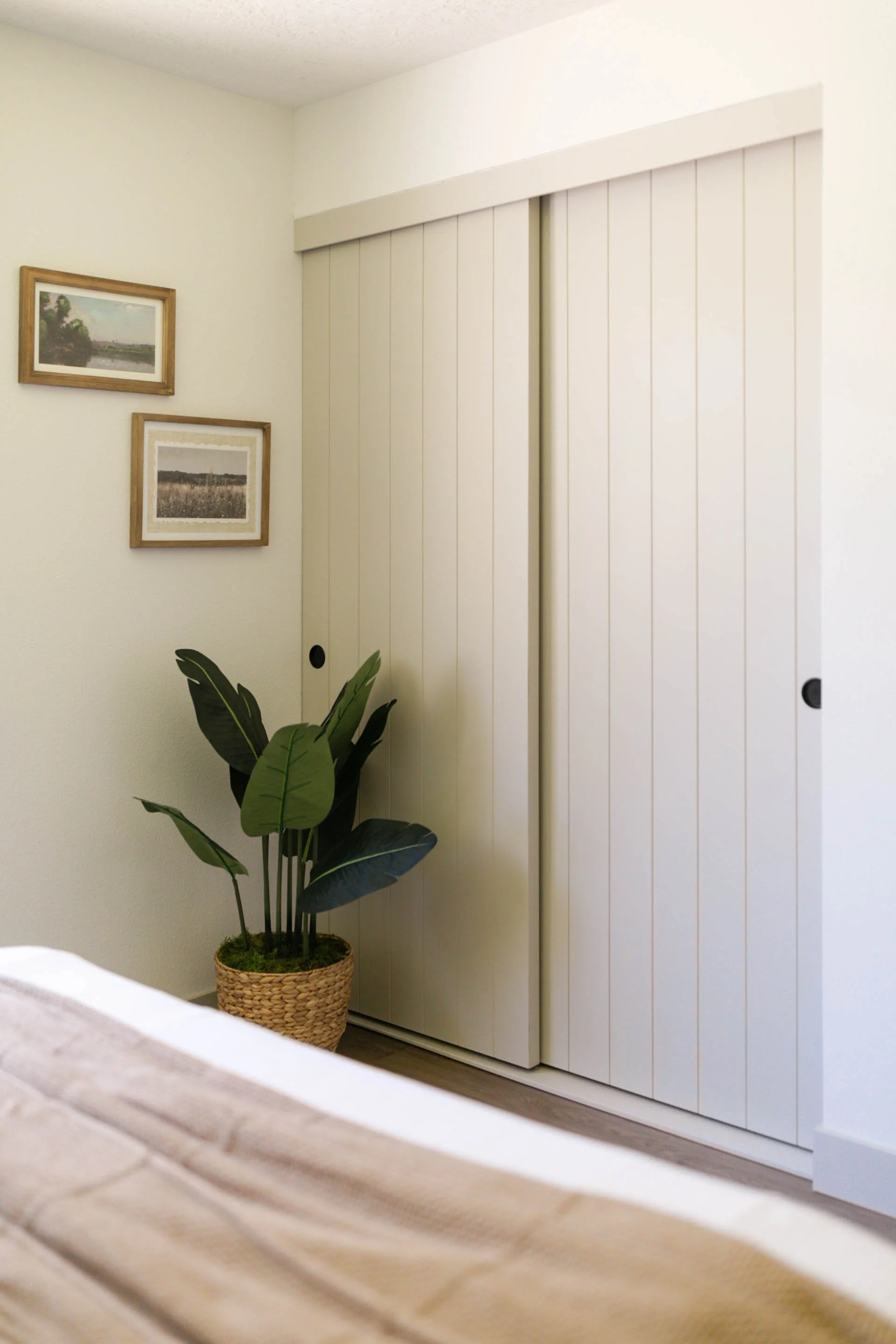 Custom sliding closet doors in a bright Portland bedroom designed by Ashley Kiely Living.