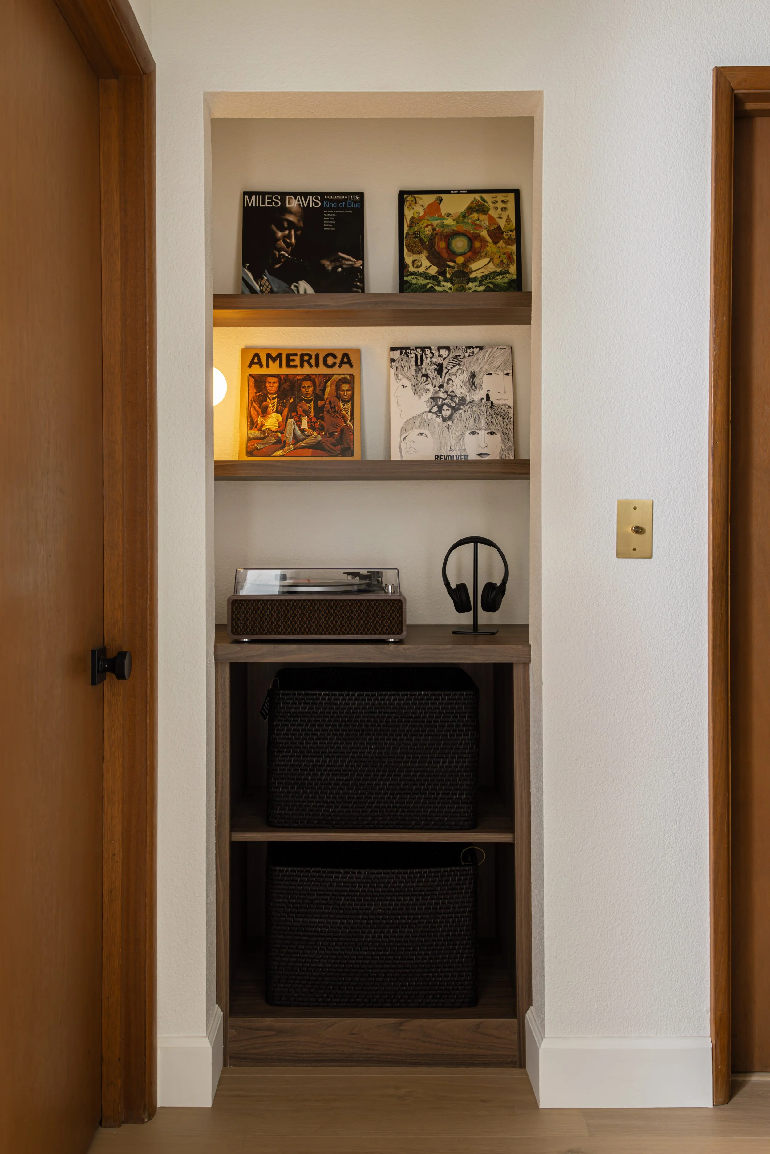 Custom record-player nook with vinyl storage, turntable and speakers in the lower level of the Canyon Lane home.