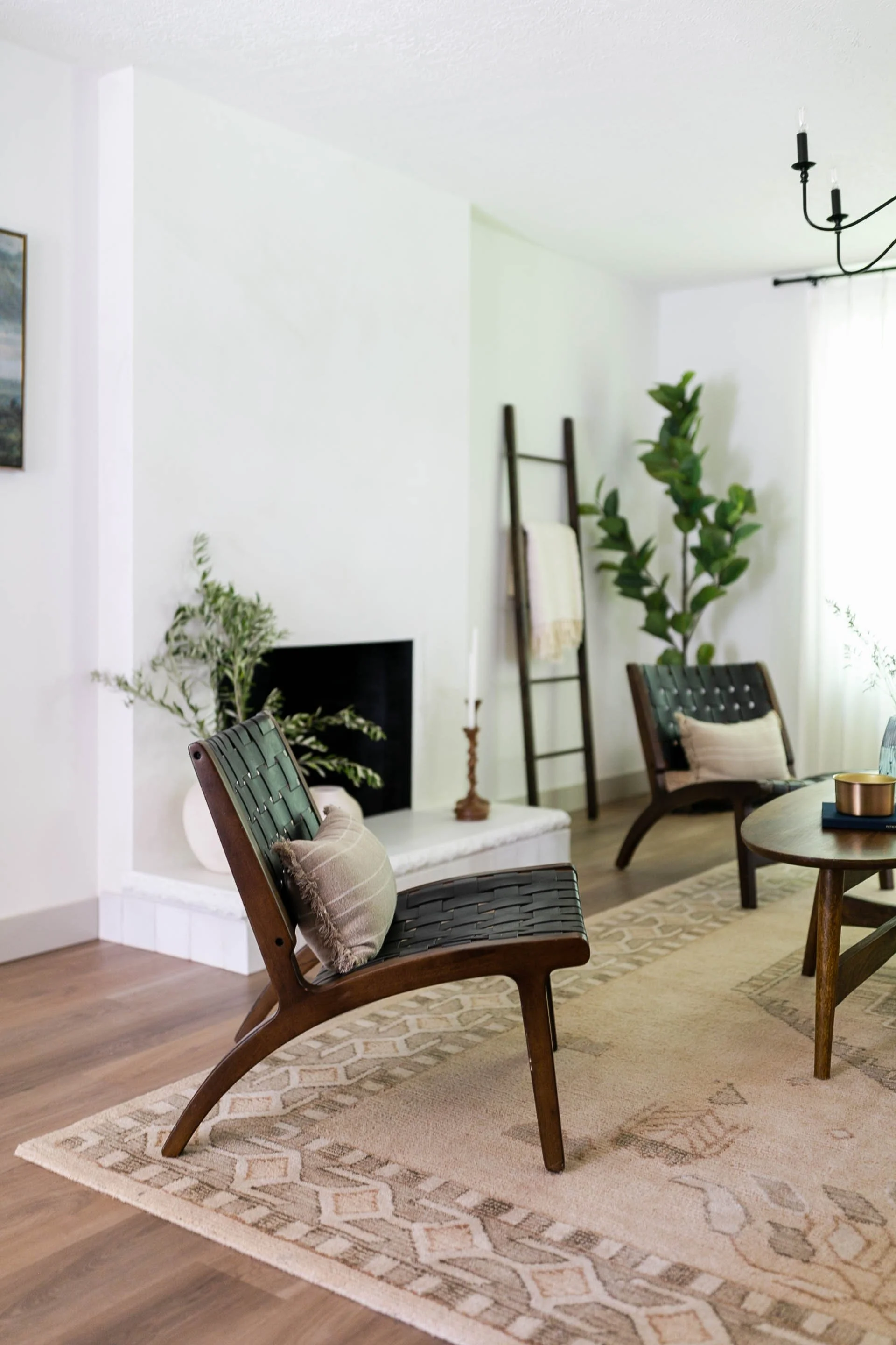 Remodeled living room with fireplace, wood flooring and thoughtfully selected furnishings.