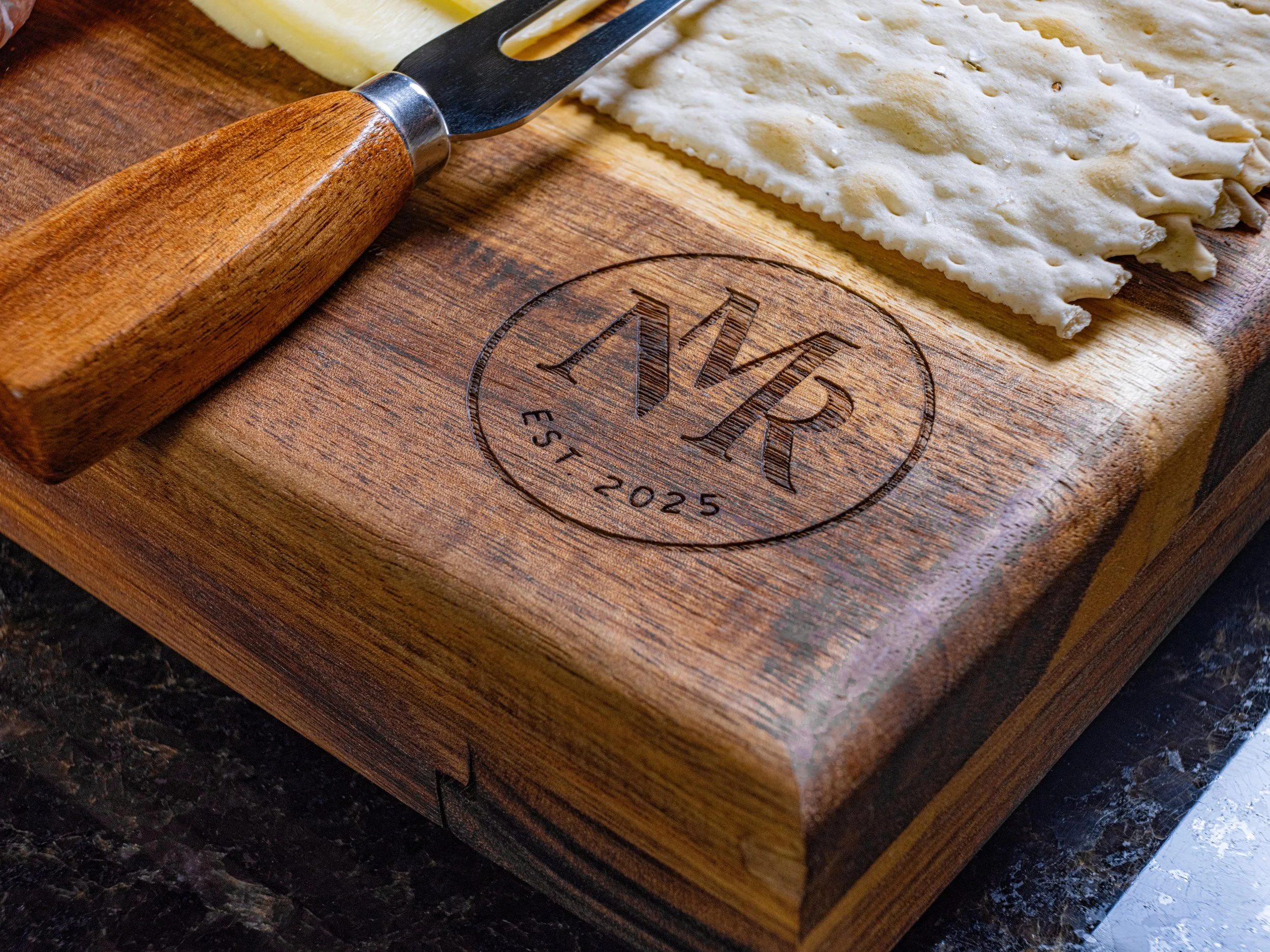  A detailed photo showing the wood craft quality of a high-end charcuterie board.