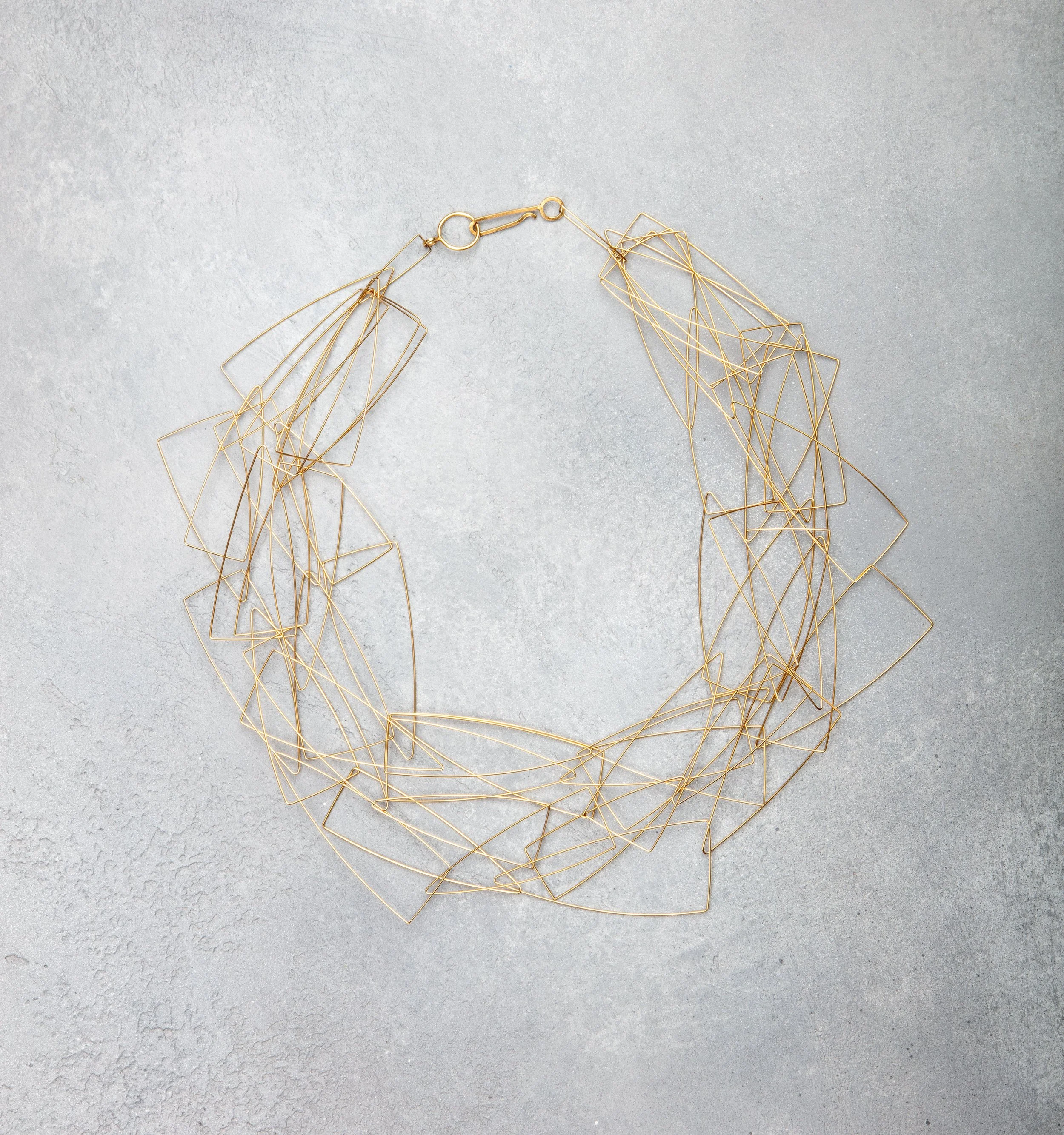 GOLD-NECKLACE-ON-GREY.jpg