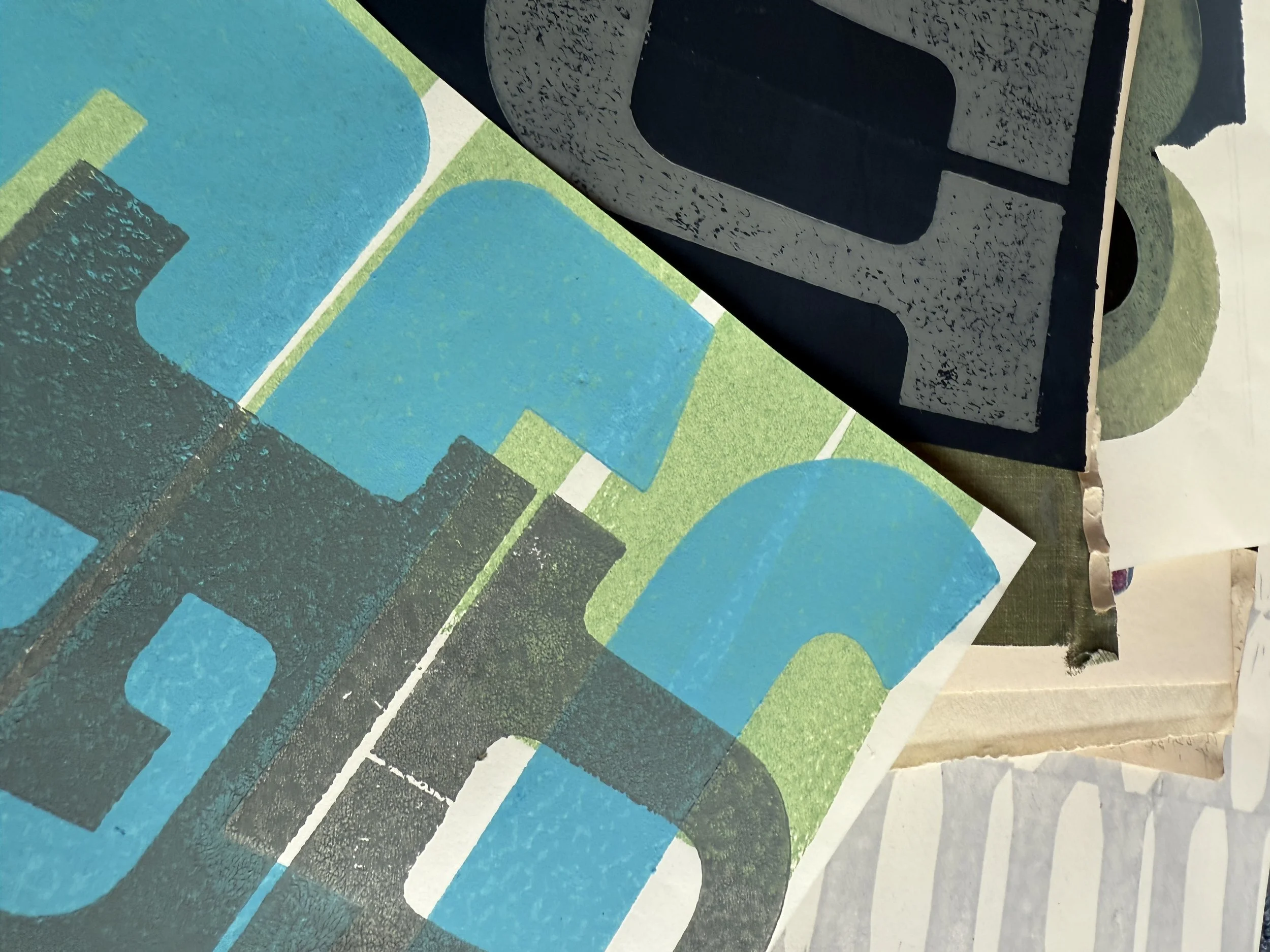 Stack of printing blocks with various geometric patterns, including blue, green, black, and gray colors.