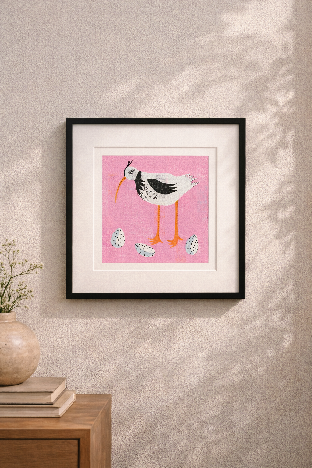 Editorial image showing room mock of art print by Clare Davis London of wading bird with white specked eggs