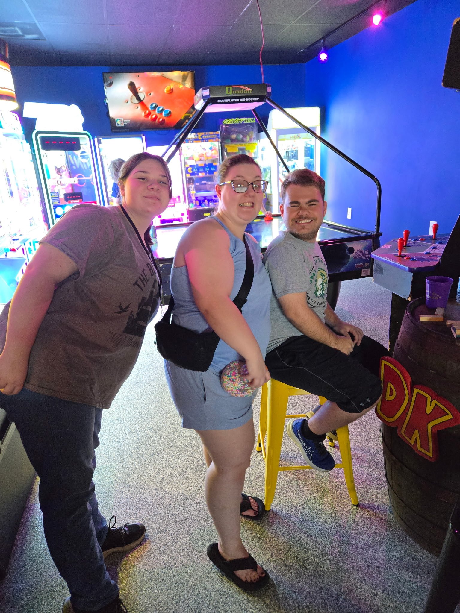 volunteers & young adult in arcade