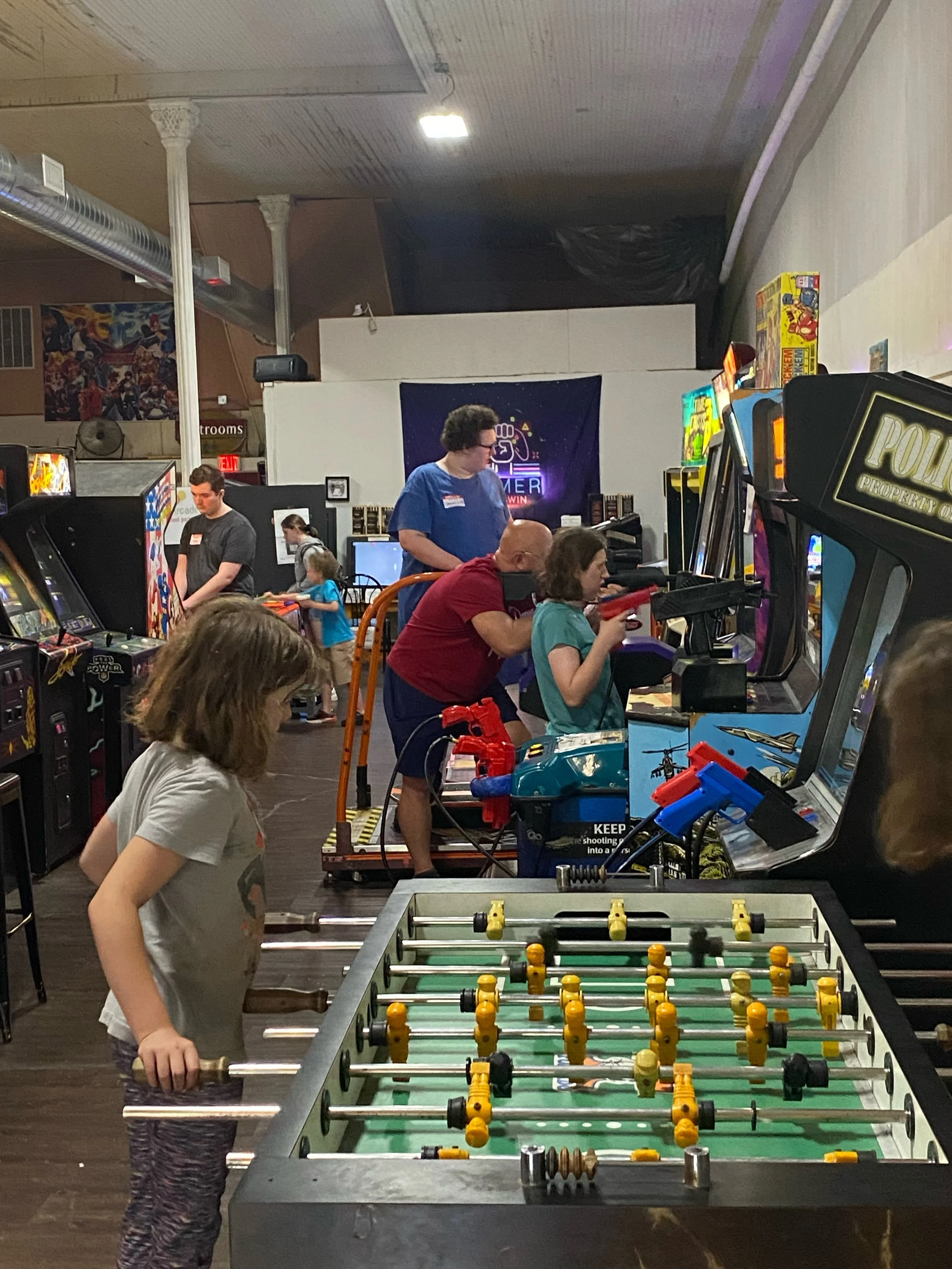 Children & families playing foosball & other arcade games
