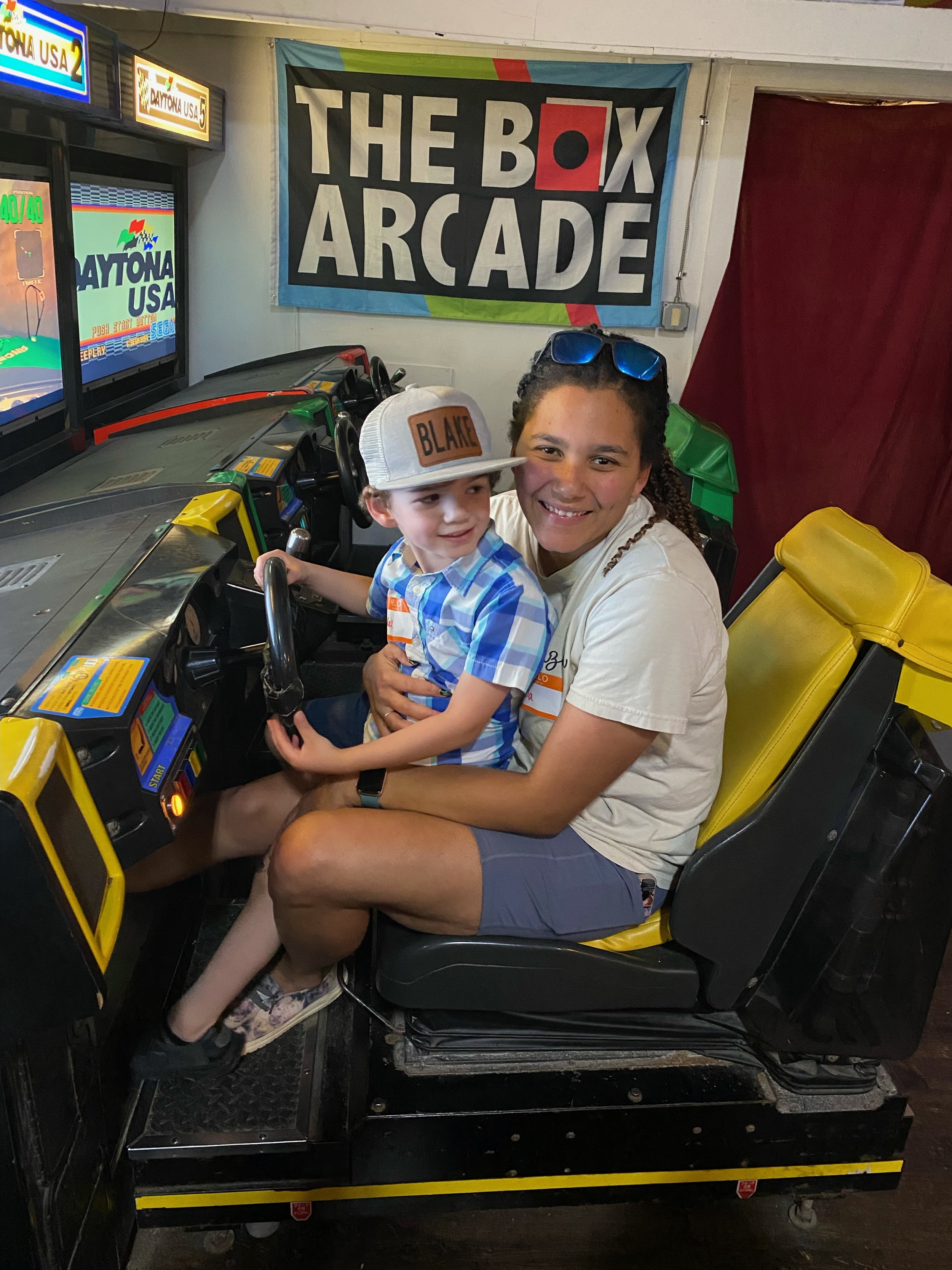 volunteer & child playing arcade game