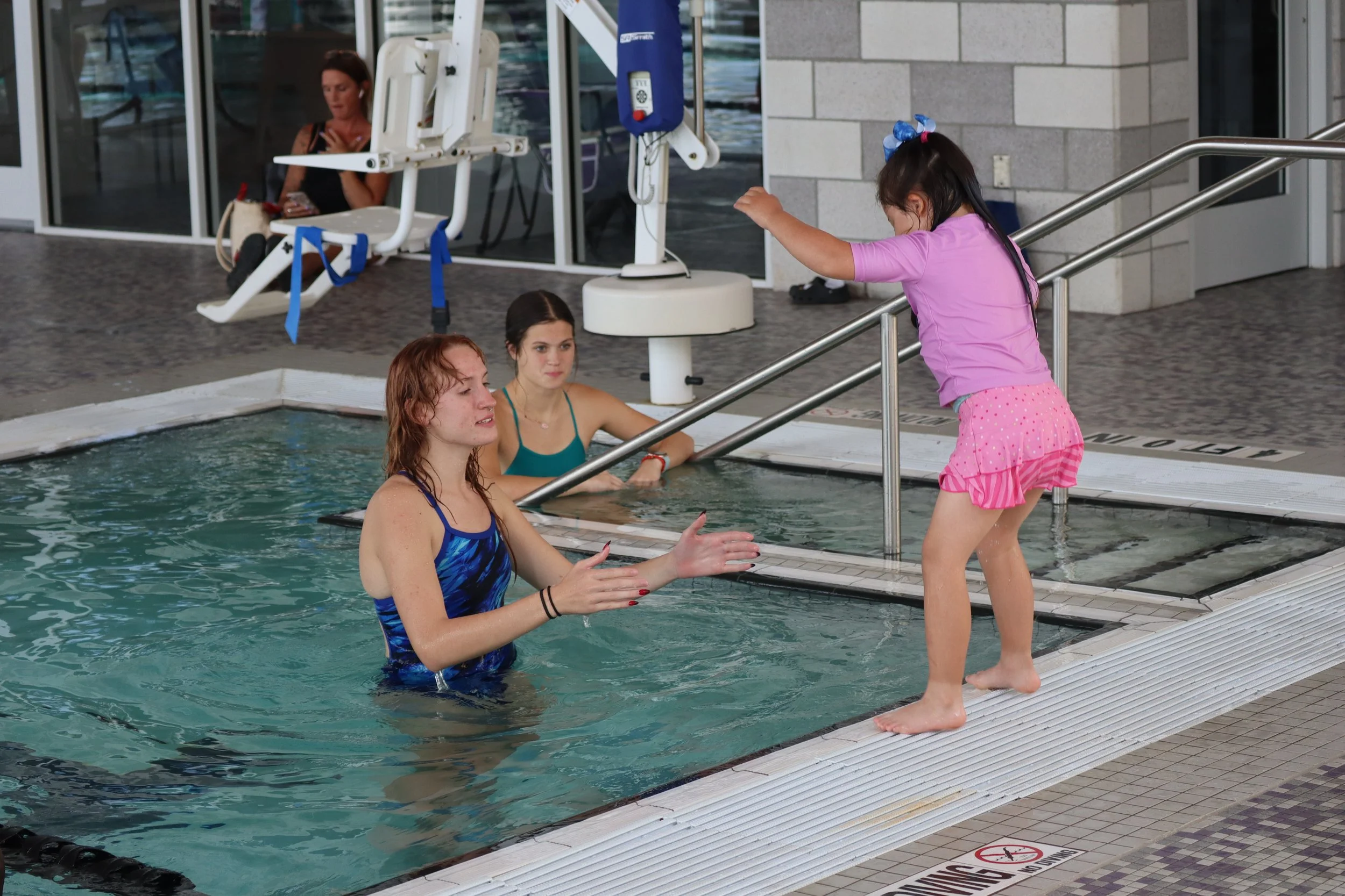girl about to jump into pool to volunteer