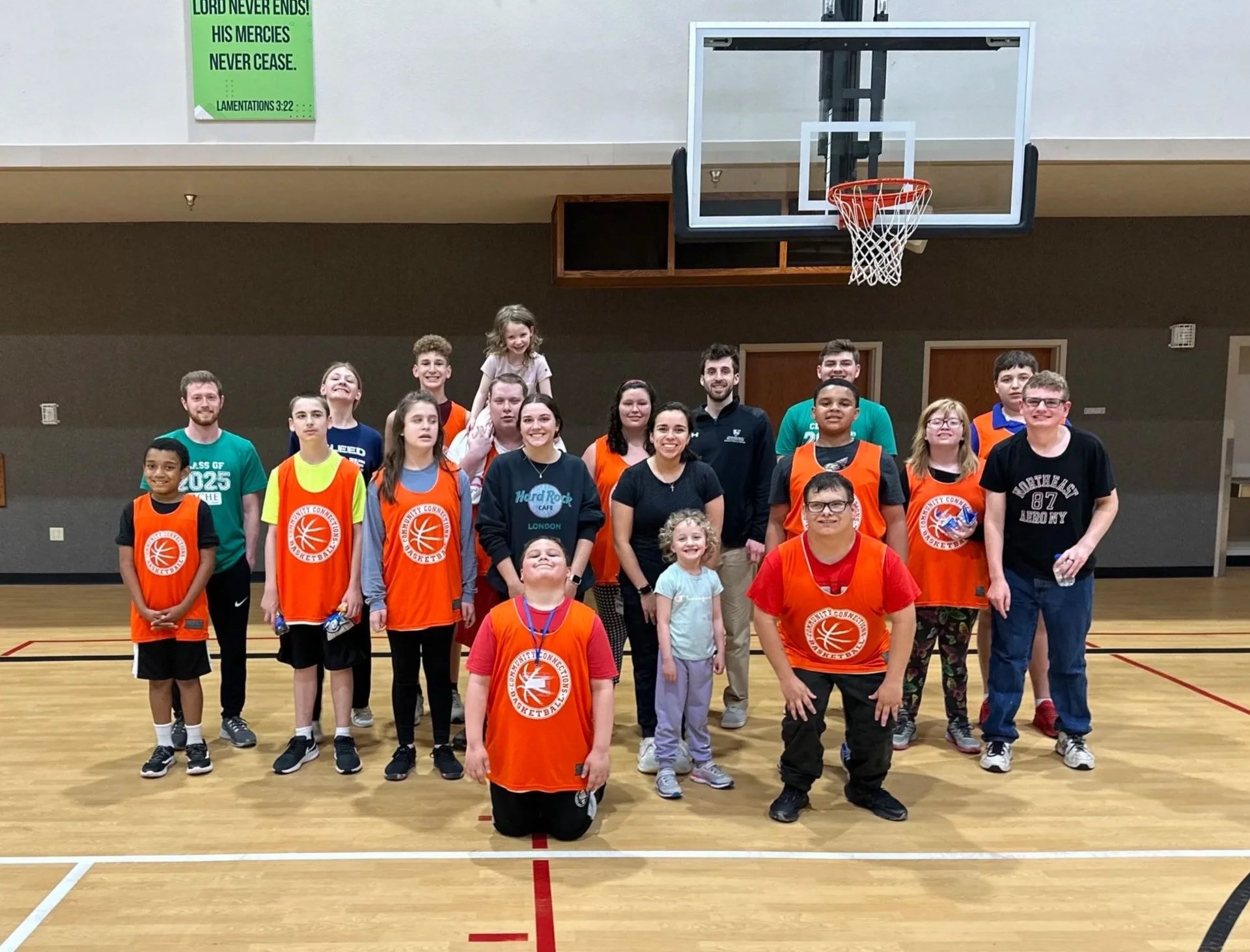 group of children & volunteers on basketball court