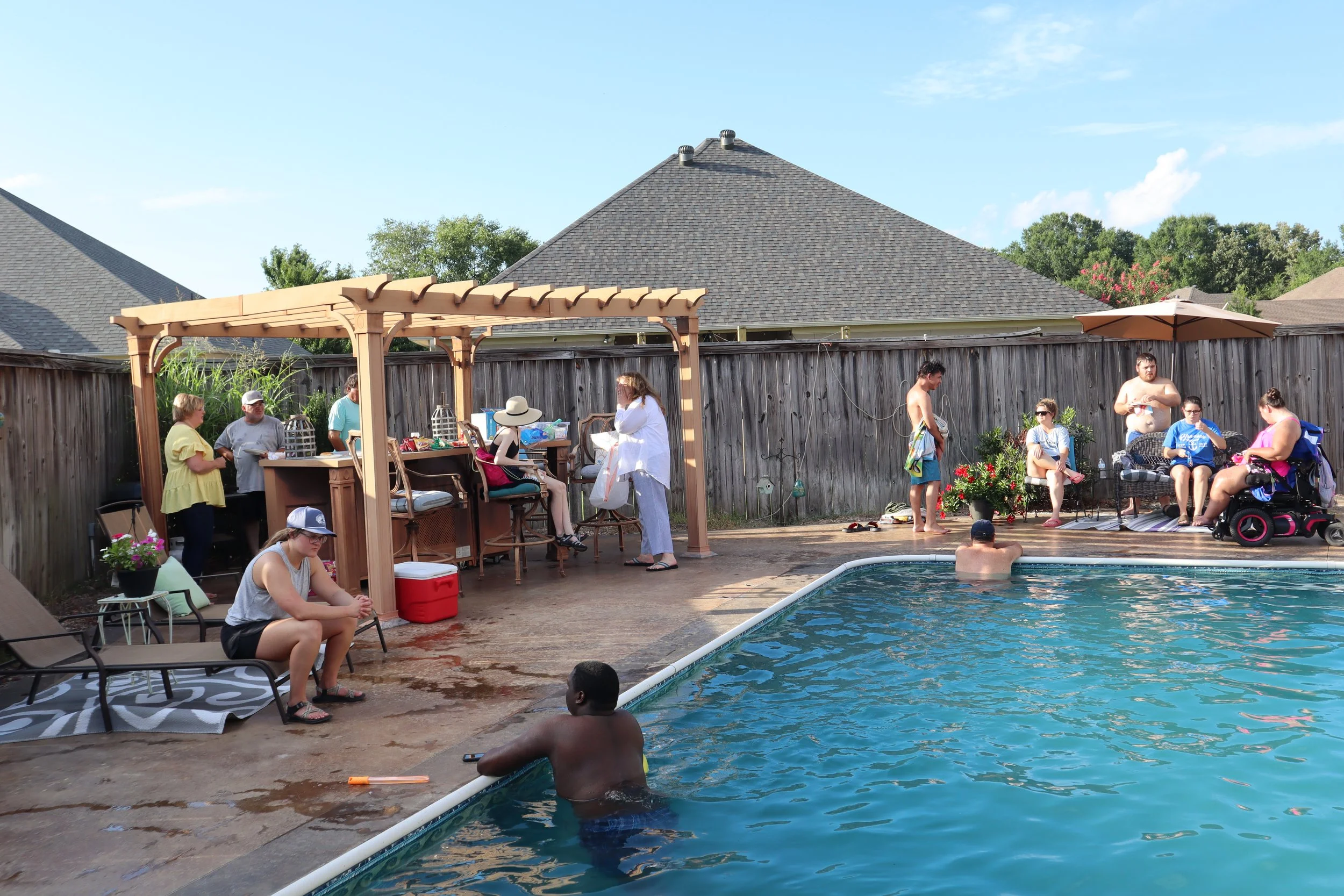 young adults hanging out at a pool