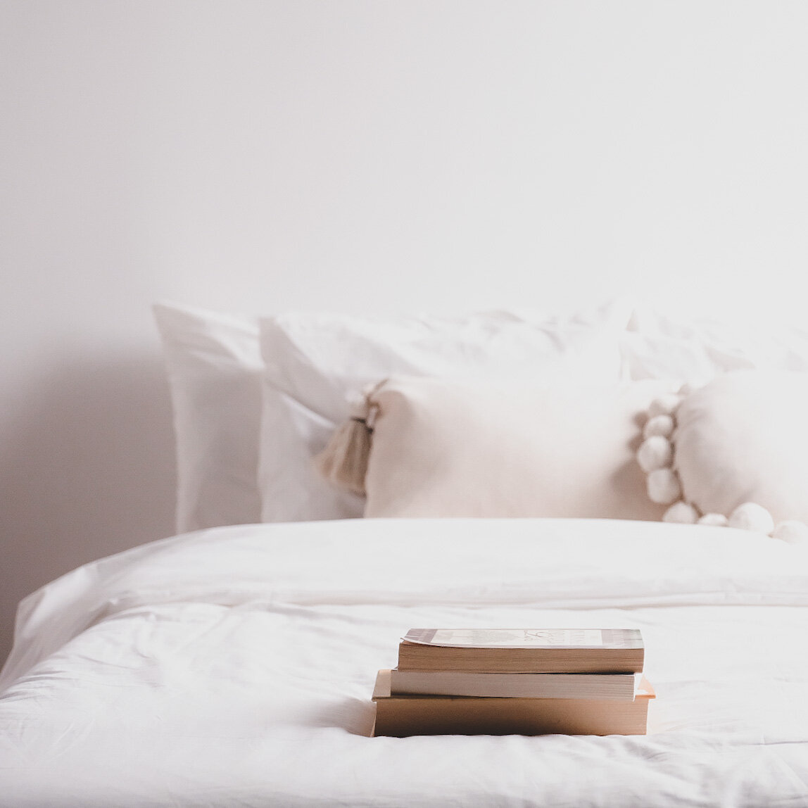 white bed with books .JPG