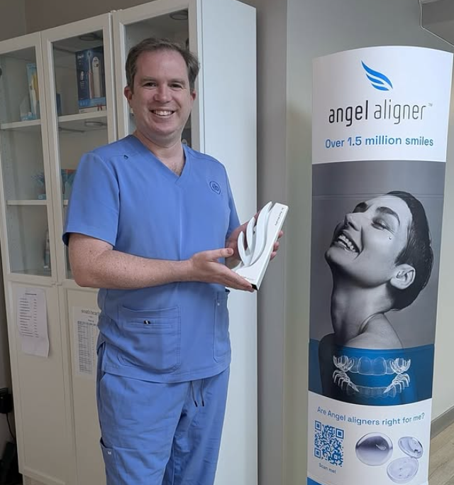 Dr Paul Murphy celebrating the milestone of treating over 100 Angel Aligner cases at South Beach Orthodontic Clinic in Greystones, Ireland.