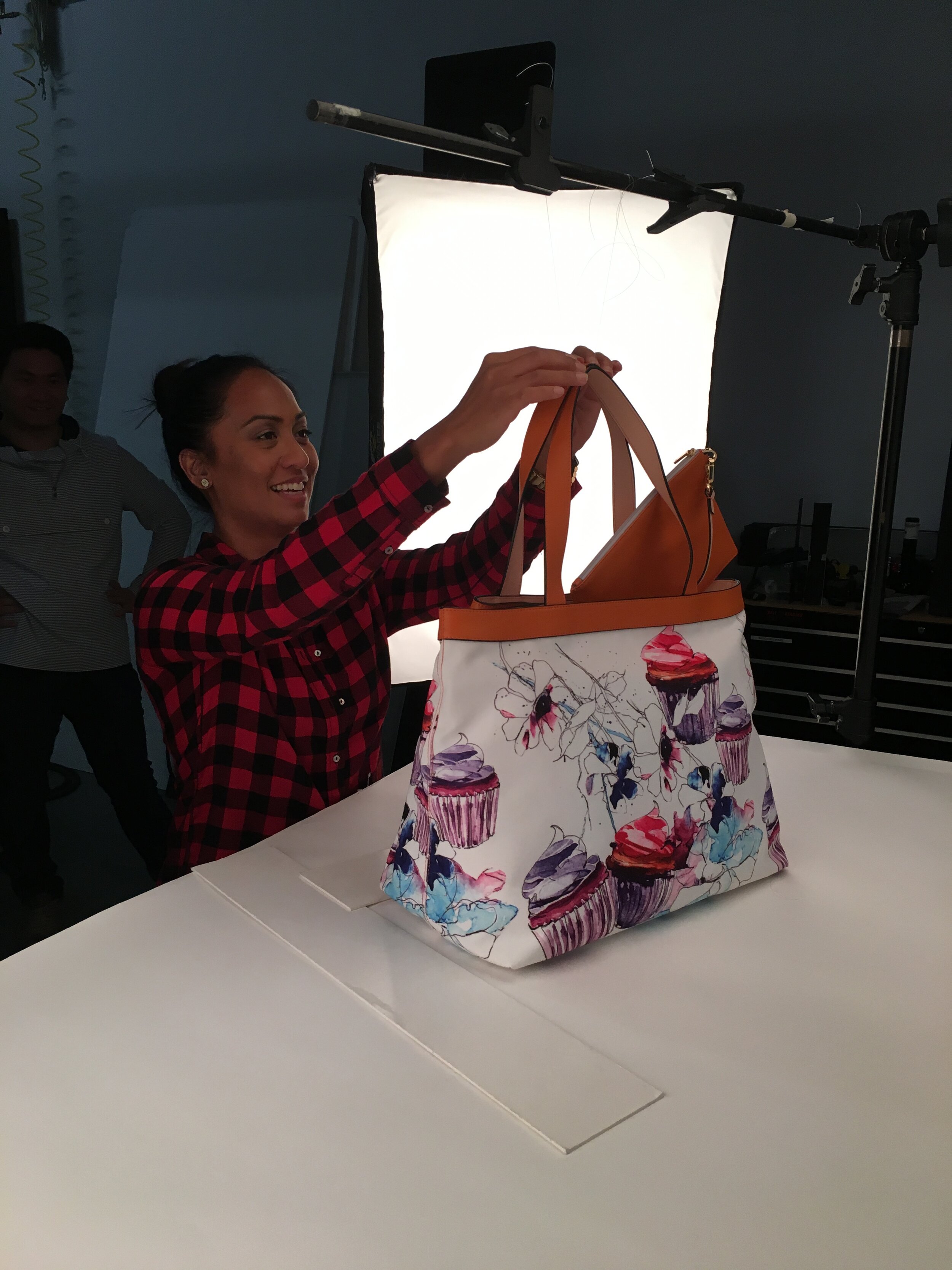 Dee Sali is styling a handbag while on set at Pacific Plus Studios. 