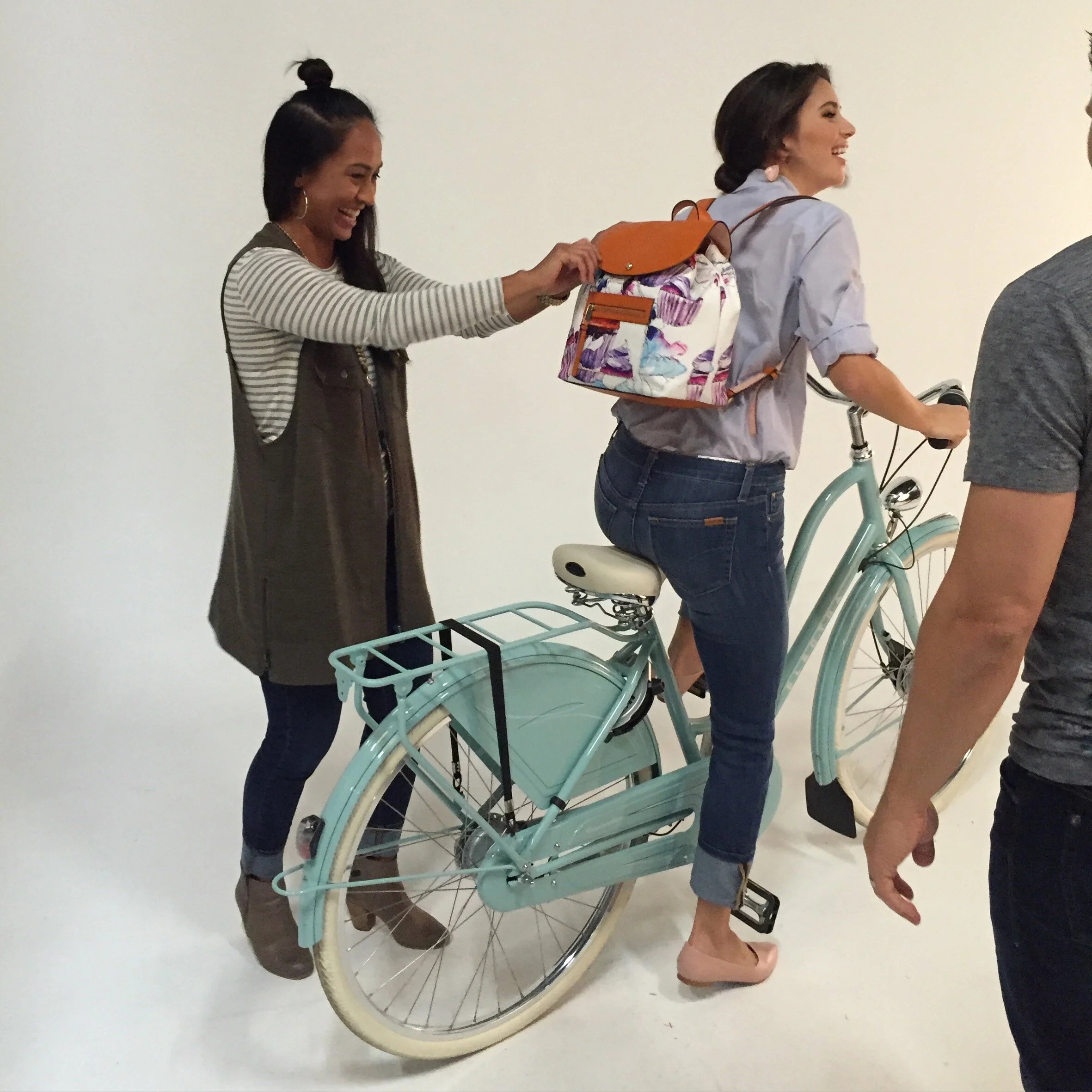 Dee styling a shot with a model for a lifestyle shoot for a handbag company. Model is on a Electra bike.