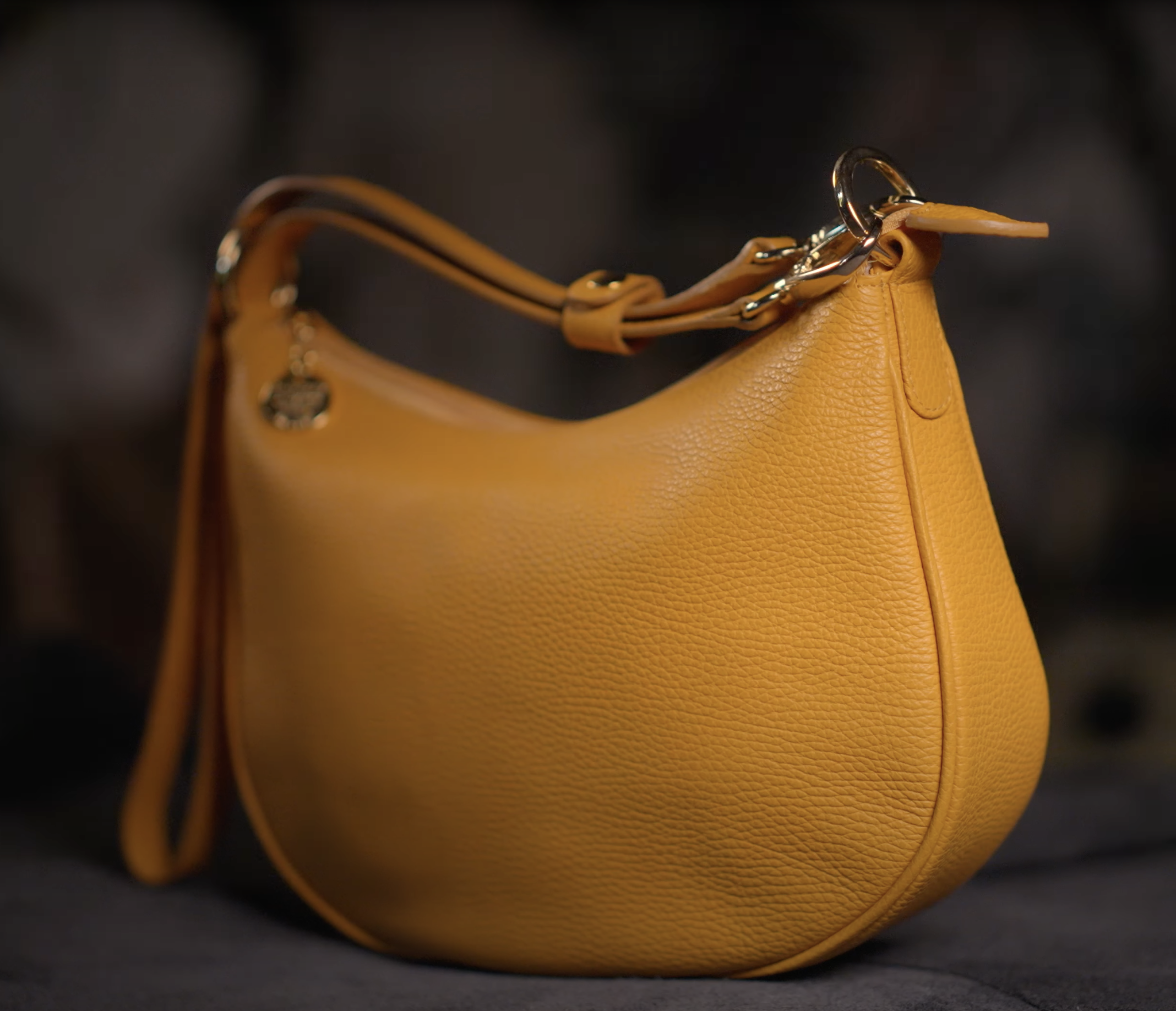 Yellow leather handbag on a dark background