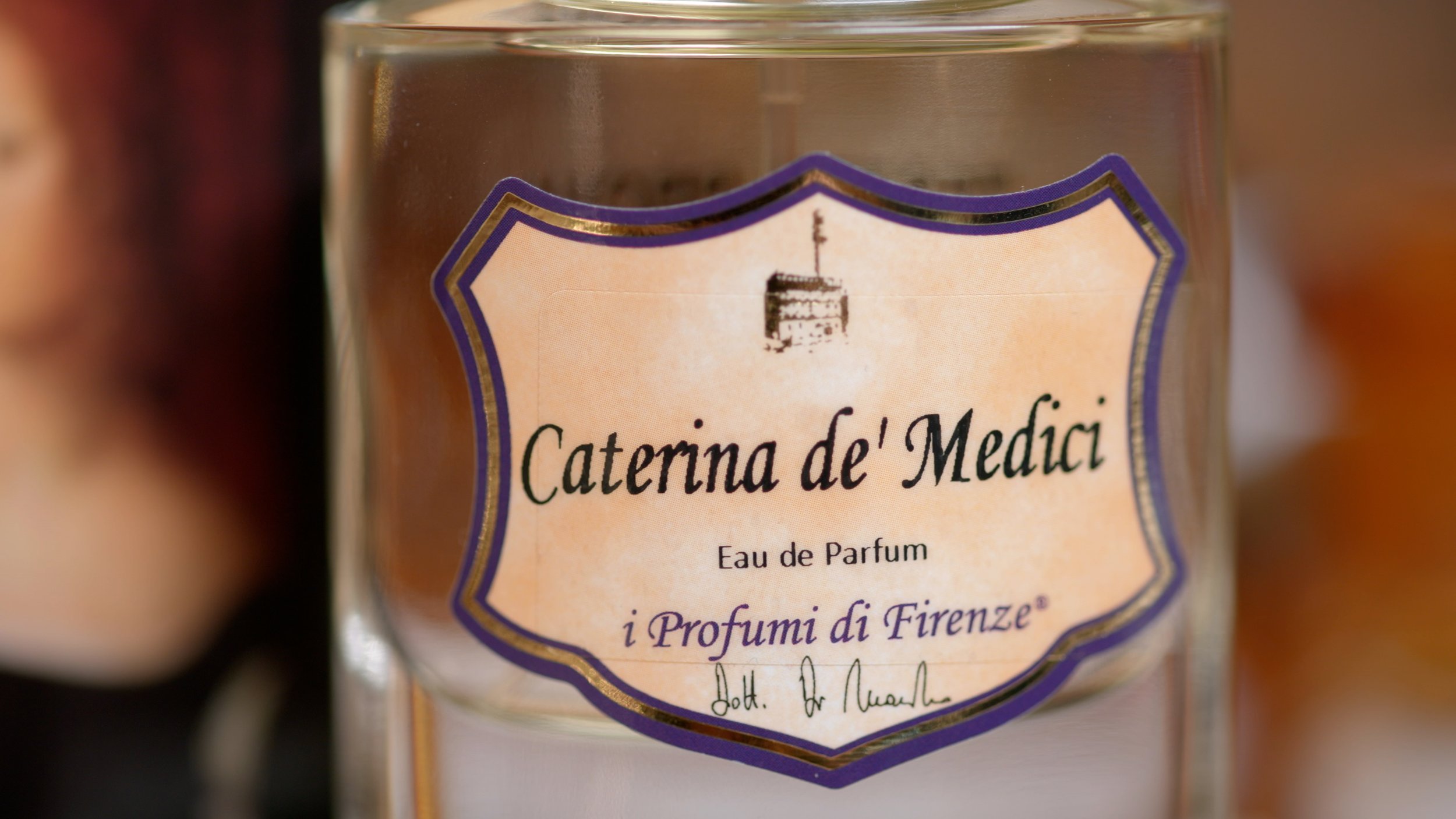 Close-up of a perfume bottle labeled "Caterina de' Medici" by i Profumi di Firenze.