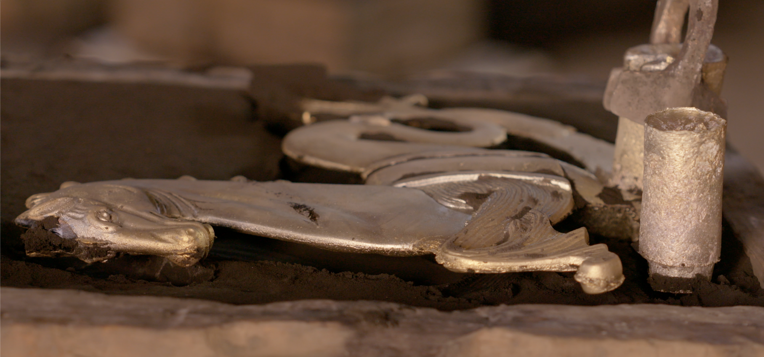 Close-up of a metal horse sculpture in a mold