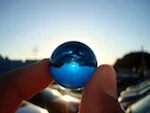 The Blue Marble Project

Image: fingers holding a blue glass marble against the sun